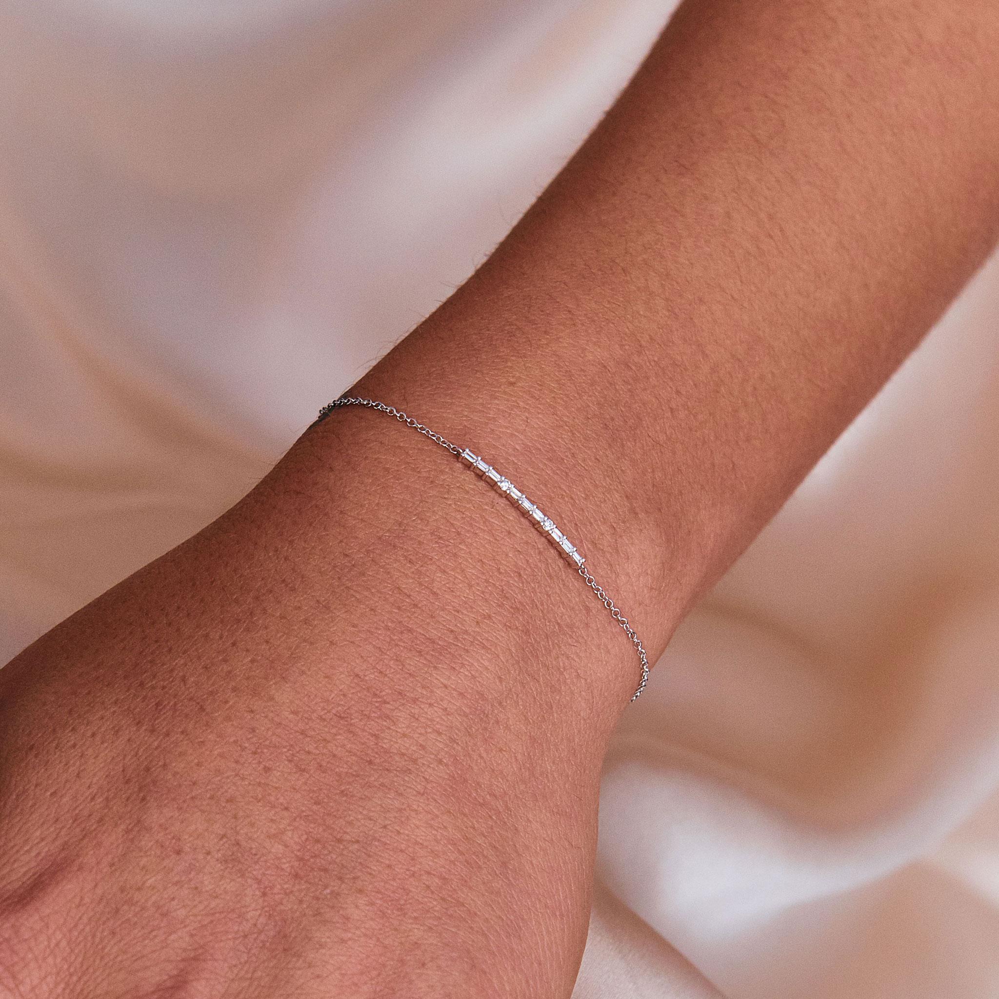 This Baguette and Round Diamond Bar Chain Bracelet is made in 14 karat White Gold, set with natural, colourless diamonds. With a total diamond carat weight (approximate) of 0.20 carat, The Diamonds are G-H colour, VS-Si clarity. Also comes in 14