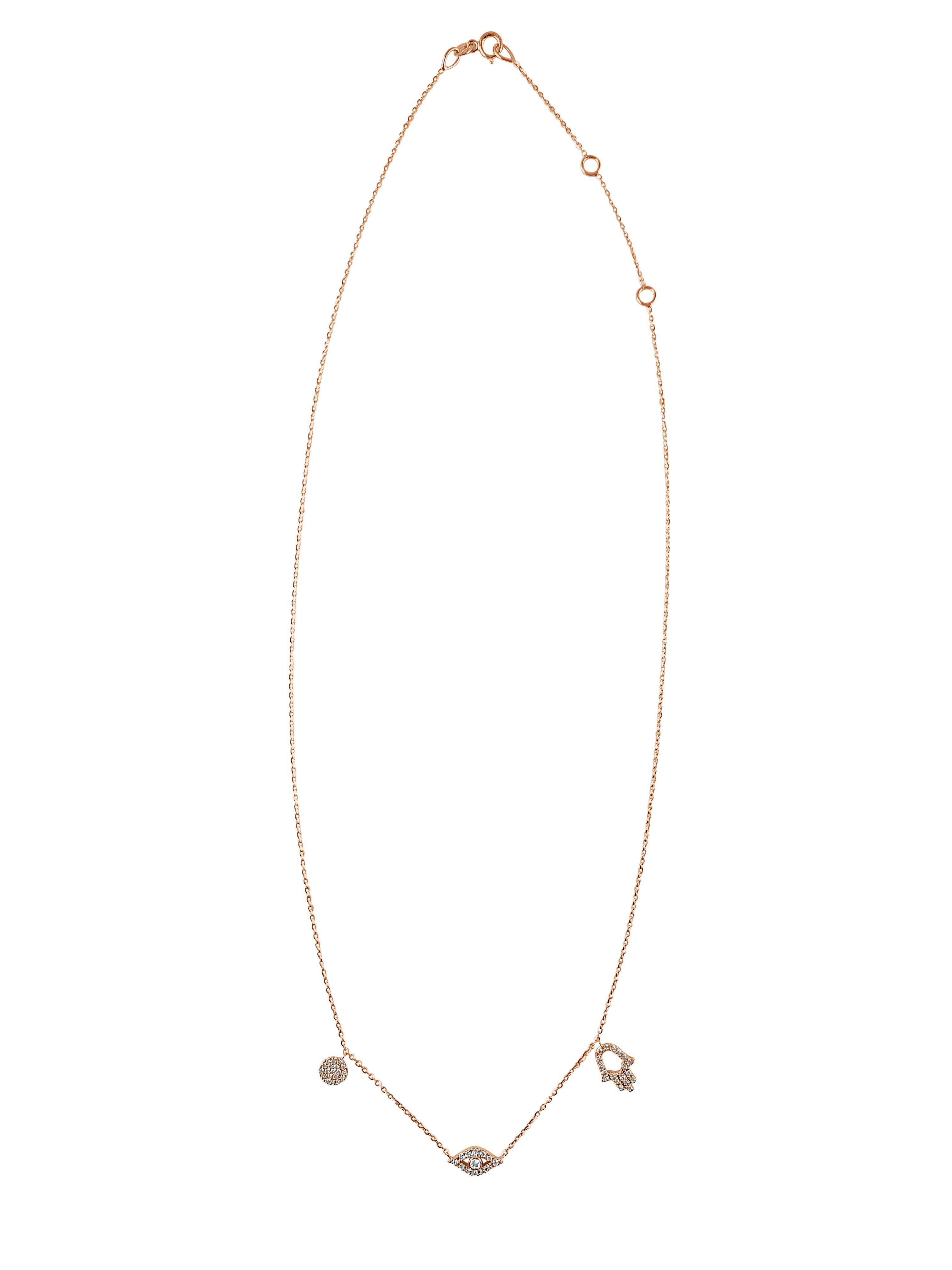 This stylish necklace for her showcases sparkling white natural diamonds that trace an eye, Hamsa and round circle disc charm. Crafted of 14k gold, the pendant has a total diamond weight of approximately 0.23 carat, and suspends from an adjustable