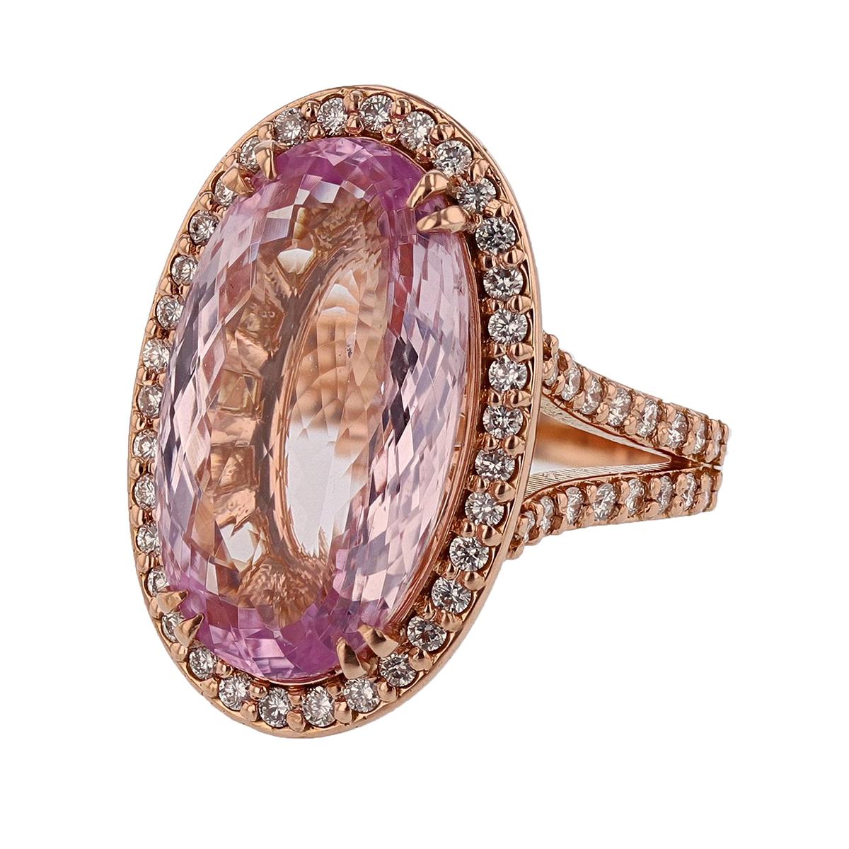This one-of-a-kind ring is made in 14K Rose gold. The center stone is a stunning, oval cut Kunzite weighing 11.94ct, prong set. The mounting also features 66 prong set, round diamonds weighing 0.80cts with a color grade (H) and clarity grade (SI2).