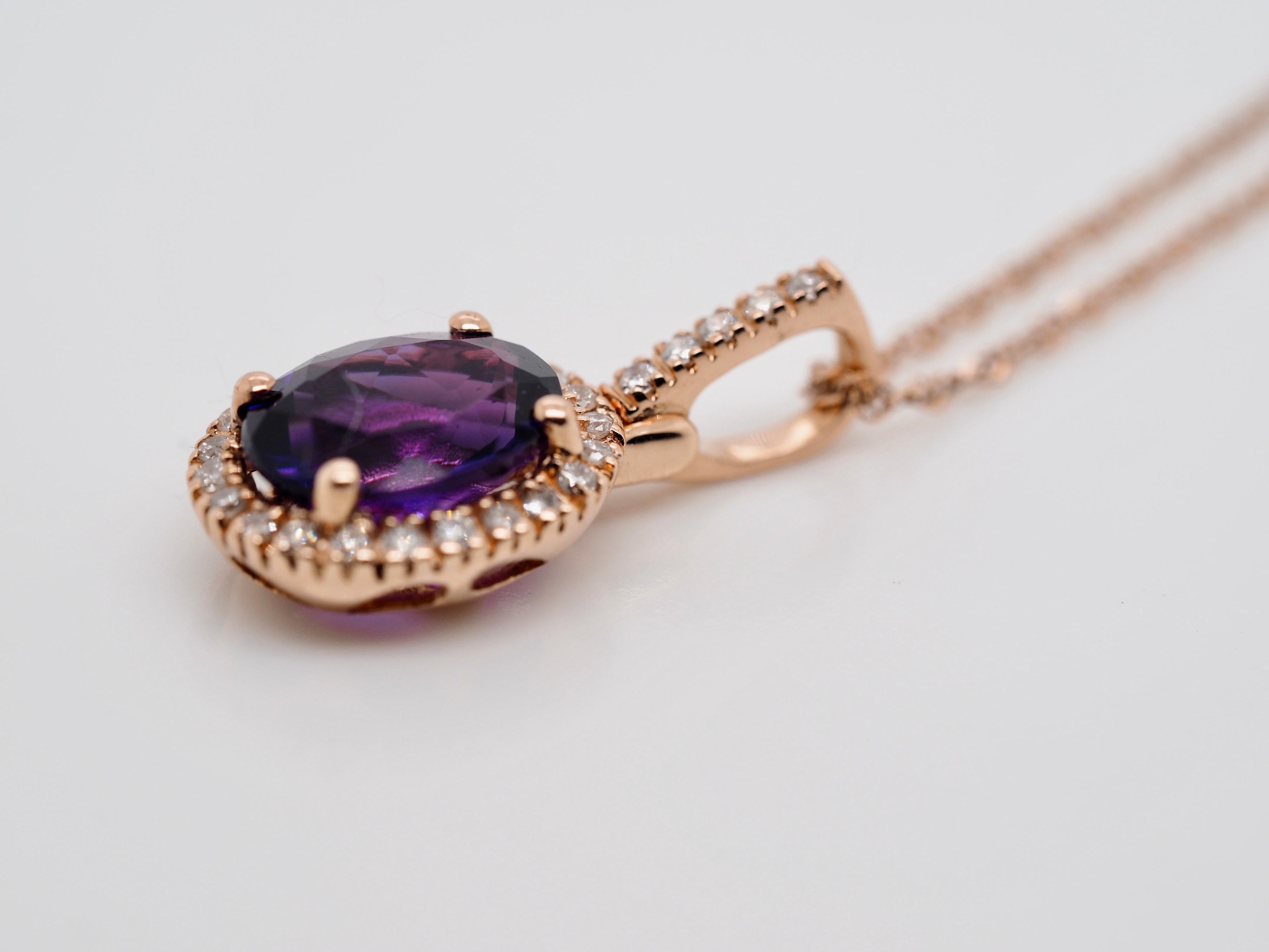 14 Karat Rose Gold Amethyst and Diamond Pendant with 17.50 Inch Chain.  The feminine pendant features an oval amethyst measuring 9.53 x 7.52 x 5.37 mm weighing approximately 1.50 carats, prong set and surrounded by a halo of full cut round diamonds