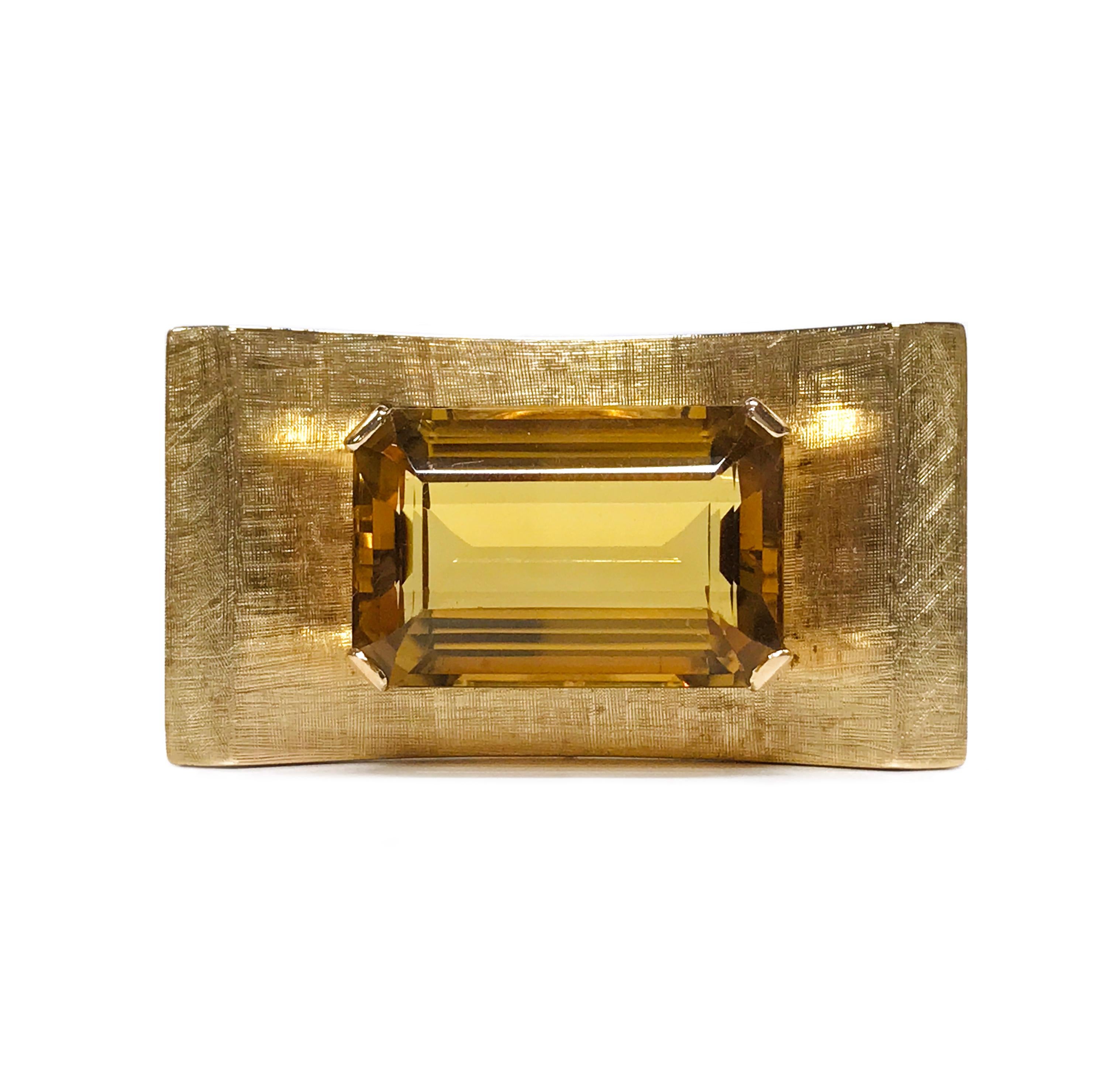 14 Karat Rose Gold tested Citrine Brooch. This handmade brooch features a large 27.47 x 13.3 x 21.00mm emerald-cut Citrine. The total carat weight of the brooch is 42.85ct. The stone is set on a curved rectangular shape with a Florentine finish on