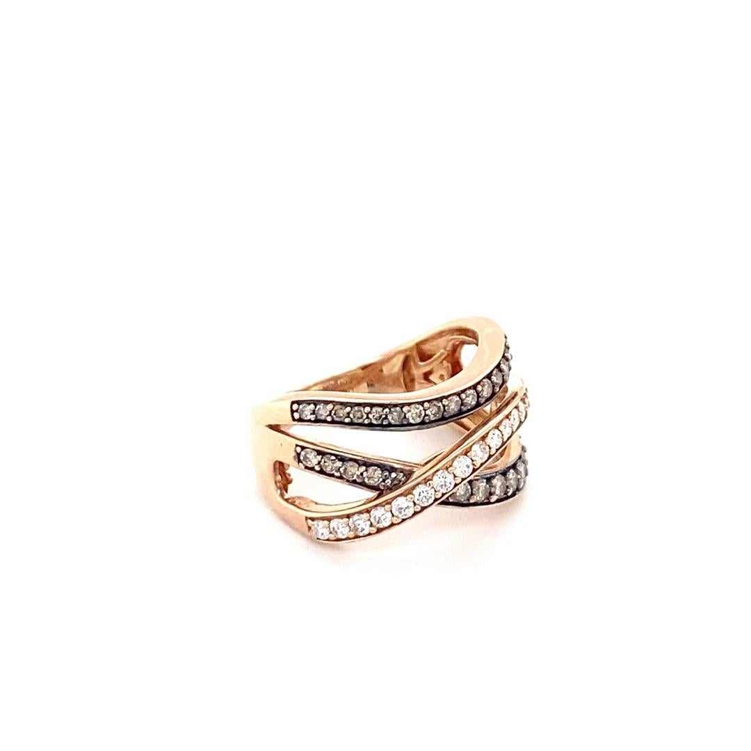 This gorgeous ring is made of 14 karat rose gold. There is 0.75cttw of white and chocolate diamonds. The ring features three band woven in a criss cross pattern. 