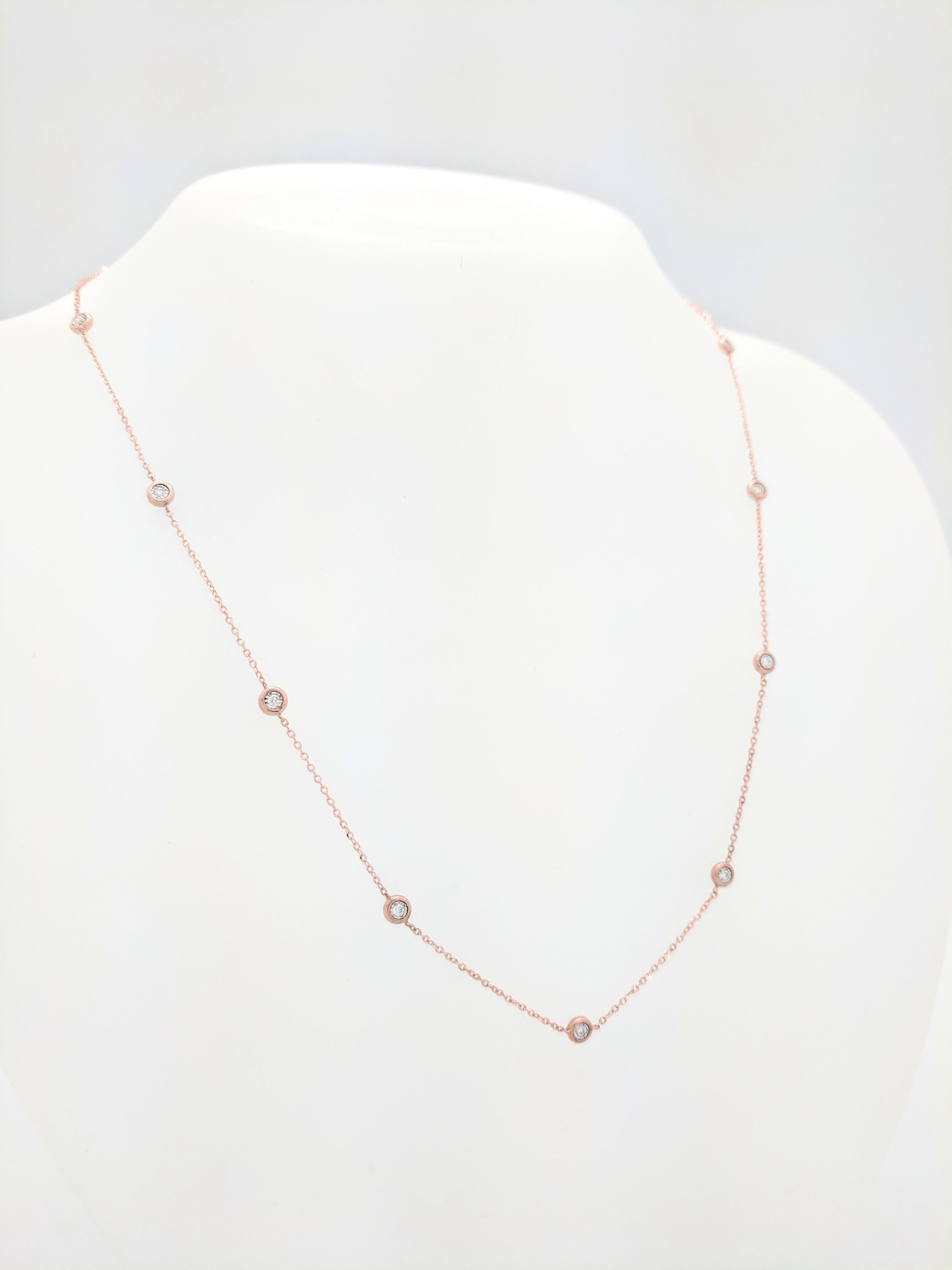 You are viewing a Stunning Diamond By The Yard Necklace. The necklace is crafted from 14k rose gold and weighs 2.6 grams. It features thirteen bezel set round brilliant diamond for an estimated .19tcw. The diamonds range from G-H in color and are