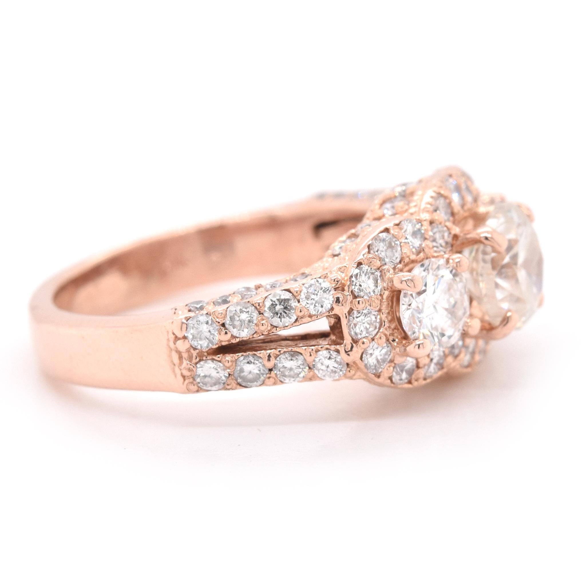 Designer: custom designed
Material: 14 Karat Rose Gold
Center Diamond: 1 round brilliant cut = .97ct
Color: L
Clarity: I1
Accent Diamonds: 76 round brilliant cut = 2.69cttw
Color: H/J 
Clarity: SI2
Ring Size: 3 (please allow two additional shipping