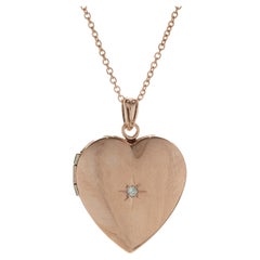 Collier en or rose 14 carats avec pendentif en forme de coeur et diamants
