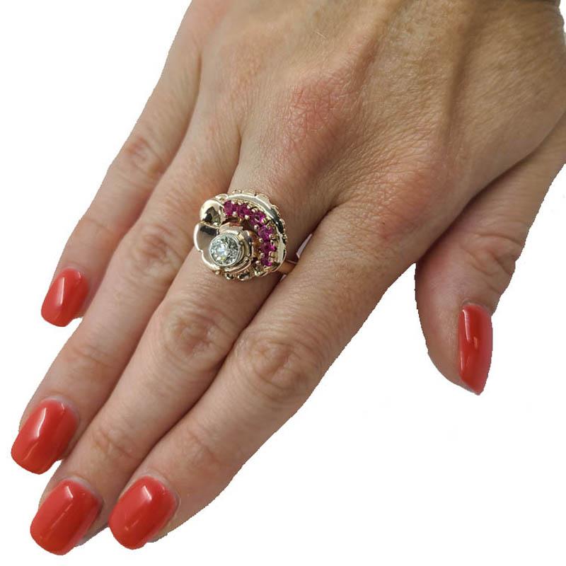 14 Karat Rose Ring Ring Featuring A Round Diamond Approximately 0.50 Carats of SI Clarity & J Color Accented By 6 Round Rubies Totaling Approximately 0.50 Carats. Finished Weight is 7.2 Grams. Finger Size 8; Purchase Includes One Free Sizing Up Or