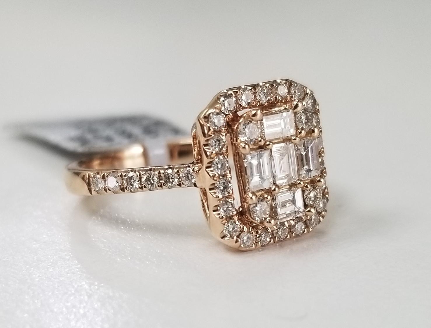 14 karat rose gold diamond solitaire halo style ring, containing 38 round full cut diamonds of very fine quality weighing .44cts. and 5 baguette cut diamonds weighing .42pts. ring size is 6.5 and is 10mm wide.