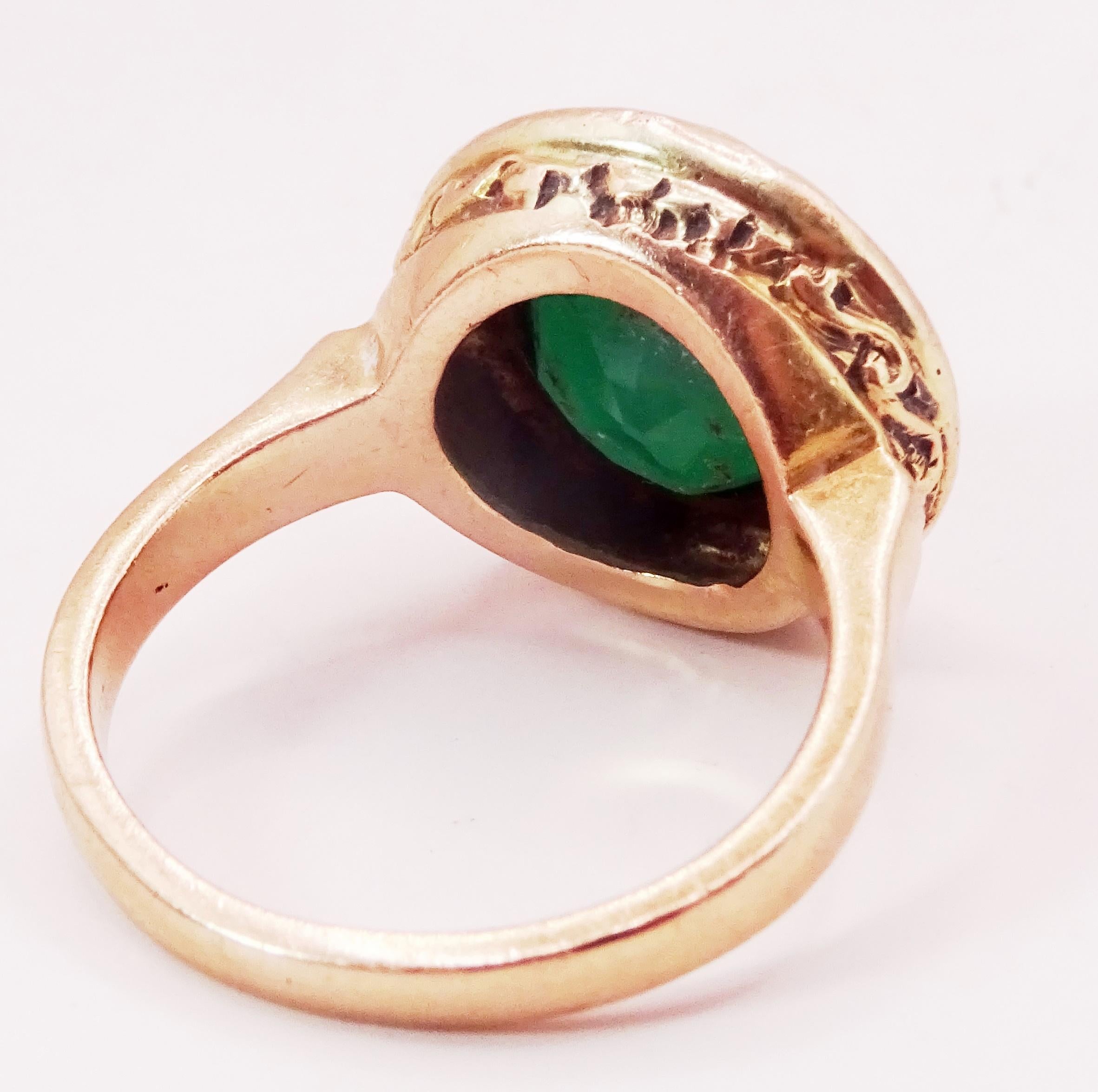 This is a contemporary ring Made in fully hallmarked 14 karat Rose Gold.
A 12 mm Round Green Agate sits in a flush setting in a crown design evocative of Victorian Jewelry.
The Ring is very well built and has a massive feeling to it
It is Size 7.5