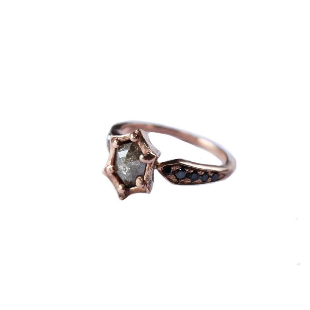 A 1,10 carat brown diamond is set in a 14k rose gold setting. A tapered band has pave black diamonds on either side. A wonderful unique piece with a low profile- its easy to wear and stack with your favorite pieces. 

Size 6