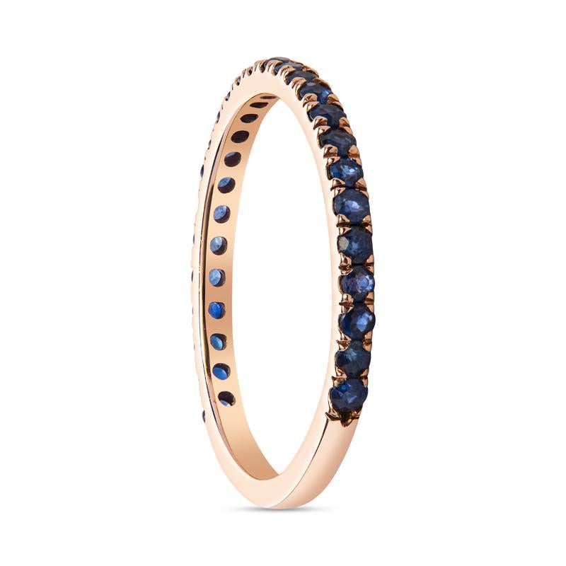 This 14 karat rose gold band features 0.55 carat total weight in round, natural blue sapphires. It can be worn alone or stacked with other bands for a one of a kind look. It currently is a size 7.75 but can be resized upon request.