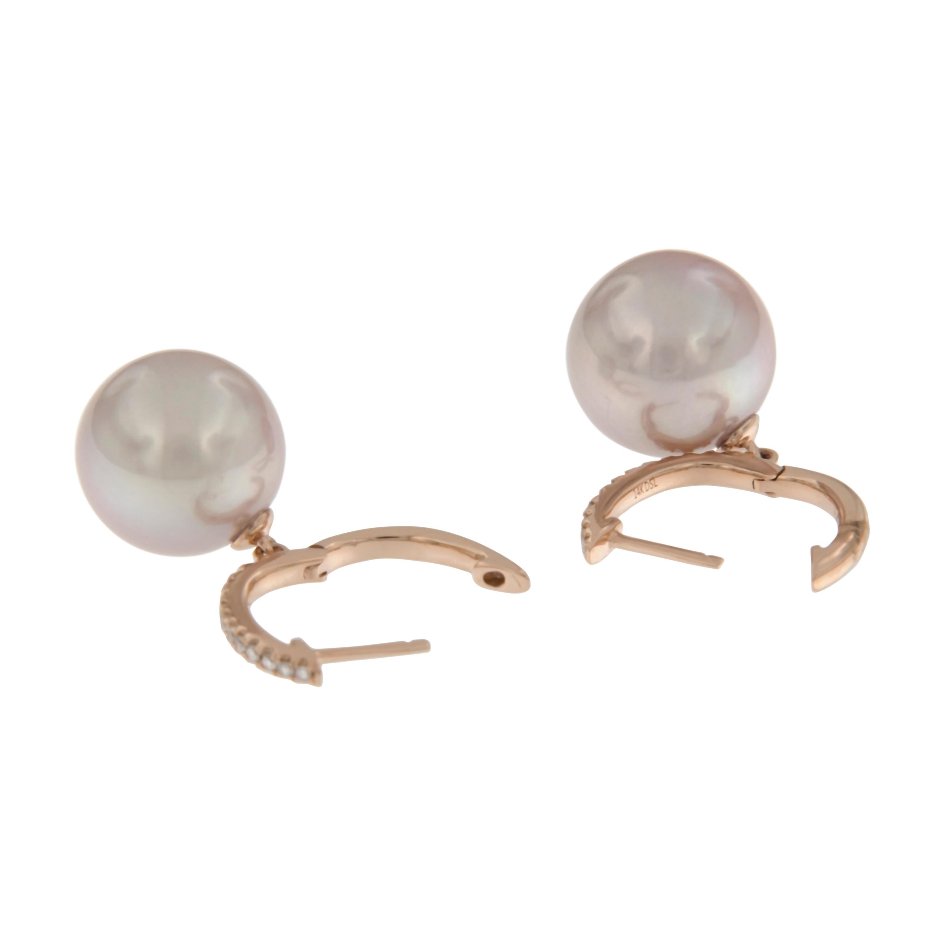 You will be tickled pink with these beautiful dangle earrings! The perfect match between the pink colored rose gold & the 11mm pink freshwater pearls which move freely from the diamond set huggy  hoop tops is breathtaking and so comfortable with no