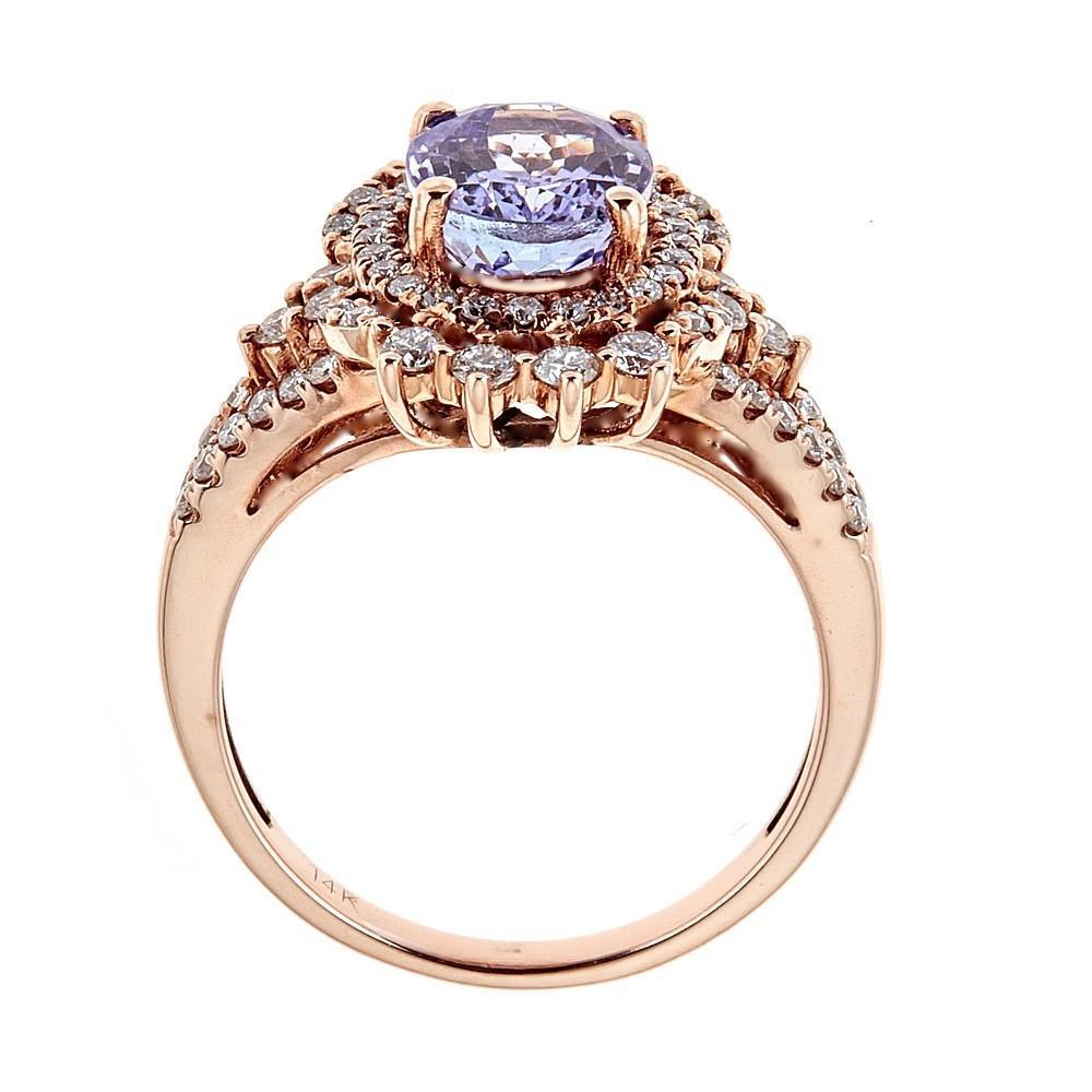 14 Karat Rose Gold Ring Natural Pink Tanzanite and Diamond Bridal Jewelry Size 7.25

Truly a ring for the Queen. Natural Pink Oval Cut Tanzanite of 2.44 TCW is centered atop of the ring. Surrounded by a double halo of shimmering round diamonds in a