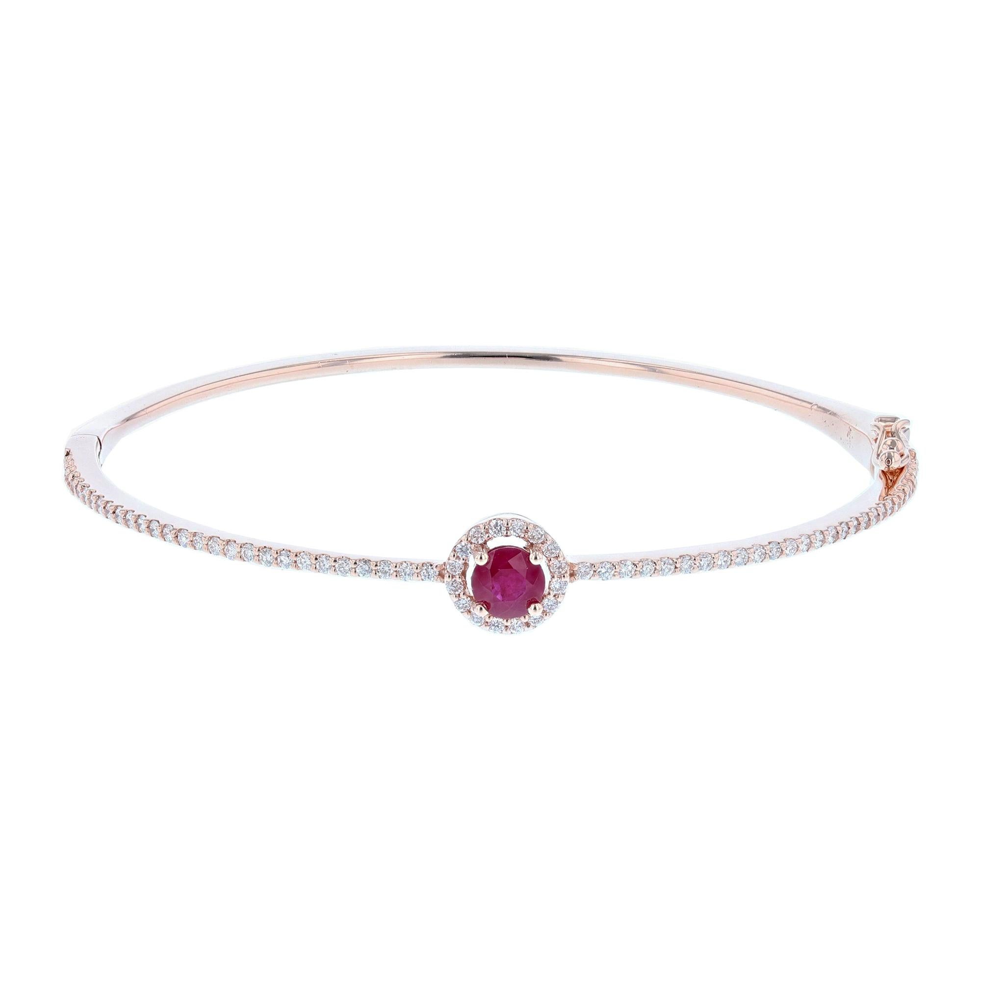 This bangle is made in 14K rose gold and features 1 Round cut, prong set Ruby weighing 0.59 carats and 72 round cut, prong set Diamonds weighing 0.63C with a color grade (H) and clarity grade (SI2).