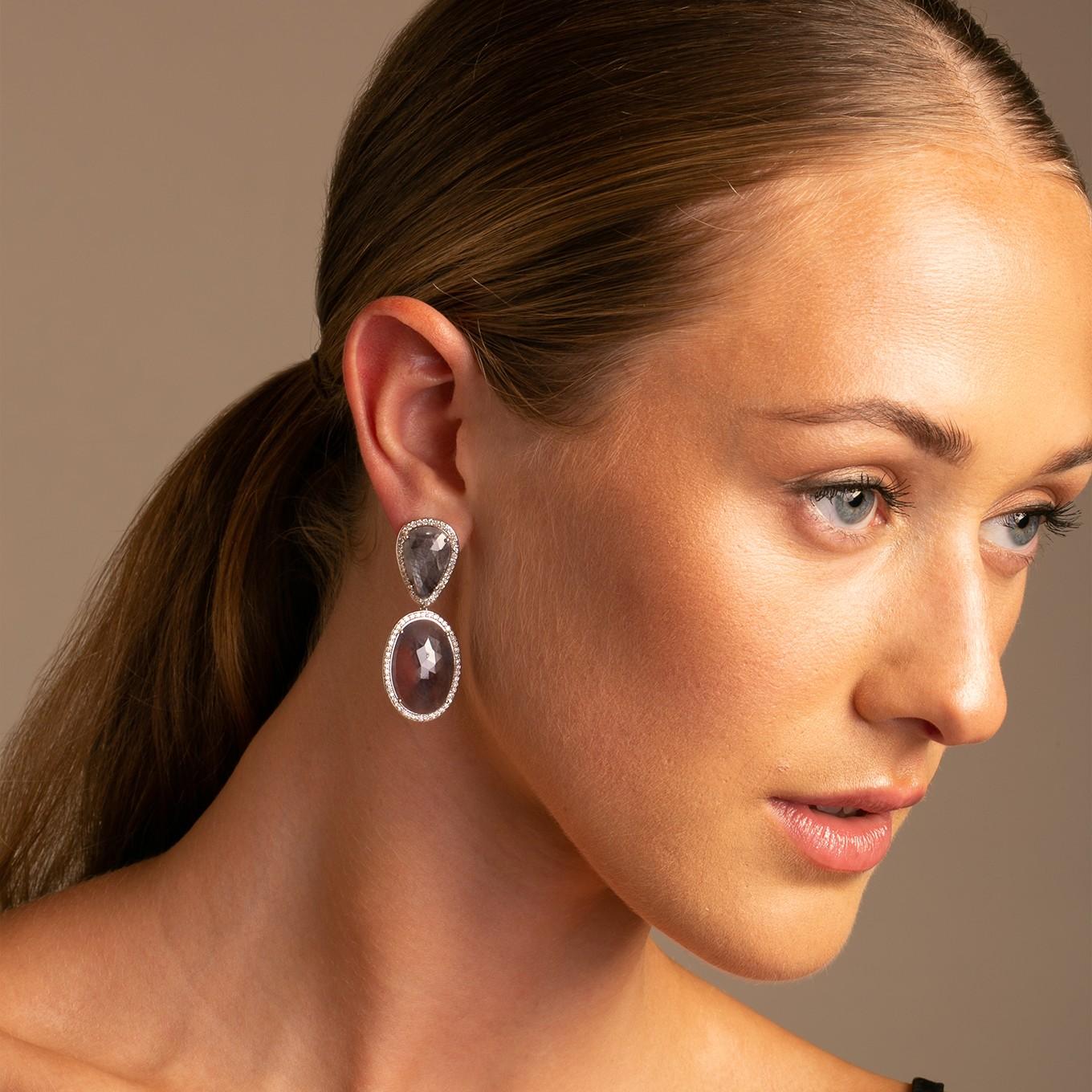 One of a Kind natural sapphire slice earrings.
These stunning earrings are crafted with precision and attention to detail, showcasing the perfect combination of natural beauty and exquisite craftsmanship.

Each earring features a pear-shaped and an