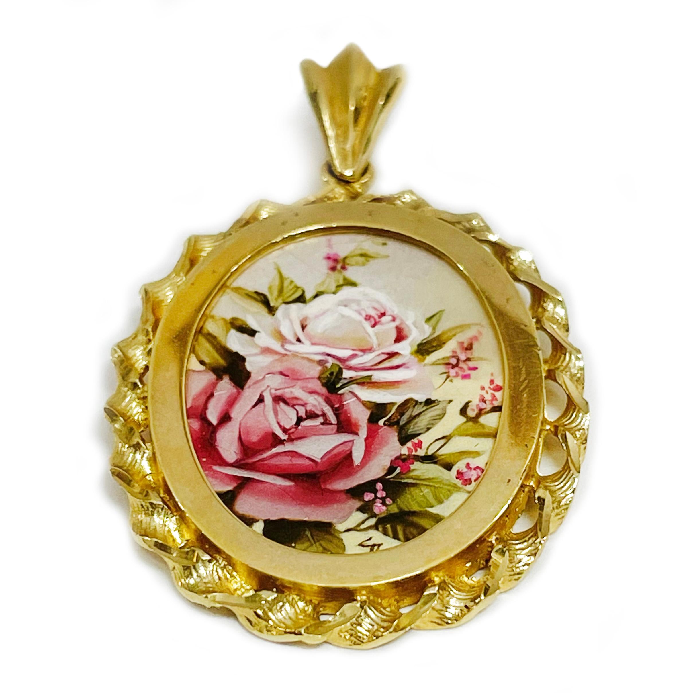 14 Karat Yellow Gold Roses Hand Painted on a Mother of Pearl Pendant. The painting features peach and pink roses with a pale pink background. The miniature painting is set in a 14 karat gold ornate oval frame with diamond-cut details. The painting