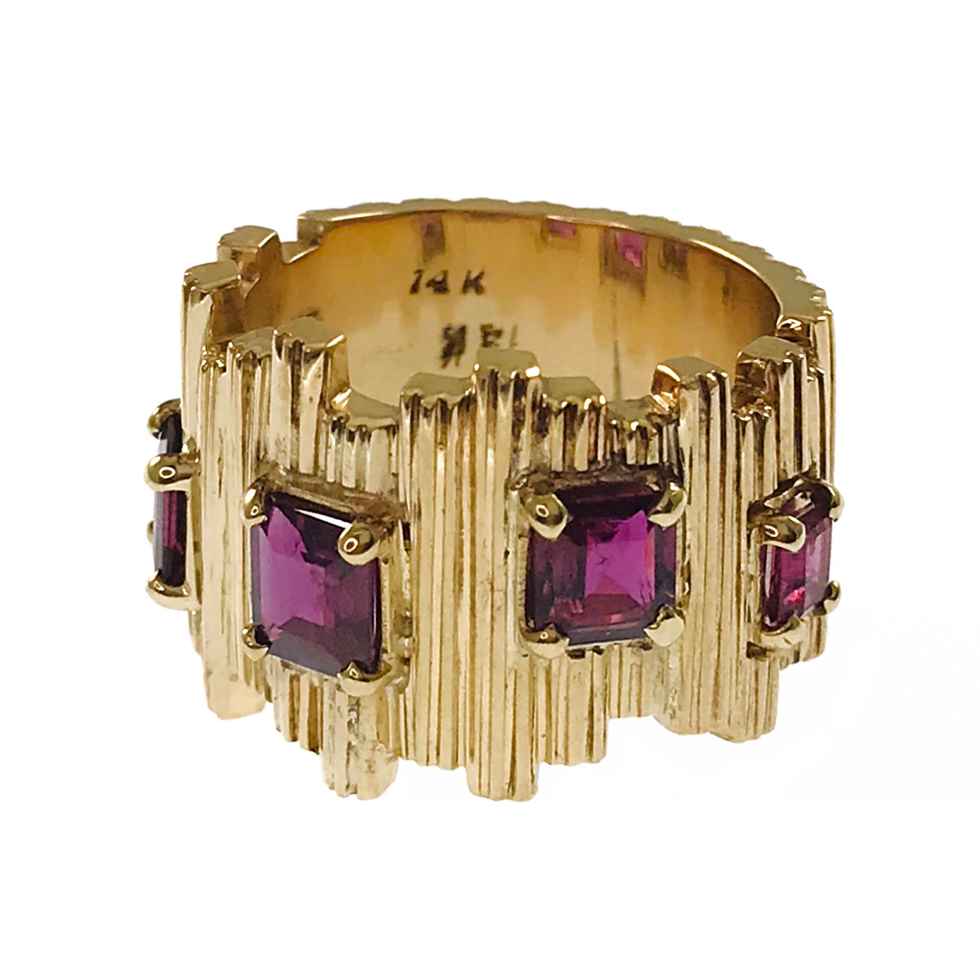 14 Karat Rubellite Tourmaline Ring. The highly textured wide band ring features five Emerald-cut Tourmaline gemstones around half of the ring. The ring is 10mm x 16.2mm. Three Tourmalines measure 4.5mm - 5.5mm for a total carat weight of 1.50ctw and
