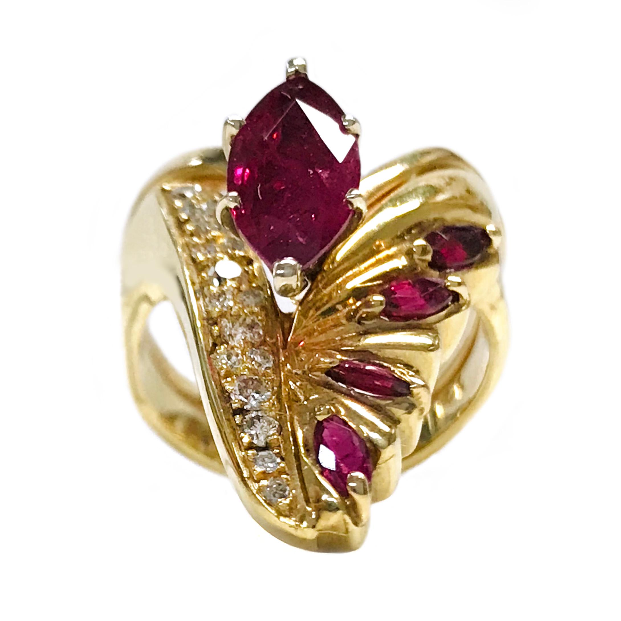 14 Karat Ruby Diamond Cocktail Ring. The spring band ring has a peak design and features an 11 x 5.5mm six prong-set marquise Ruby, four smaller prong-set marquise Rubies, and sixteen bead-set round diamonds set vertically. The primary Ruby has a