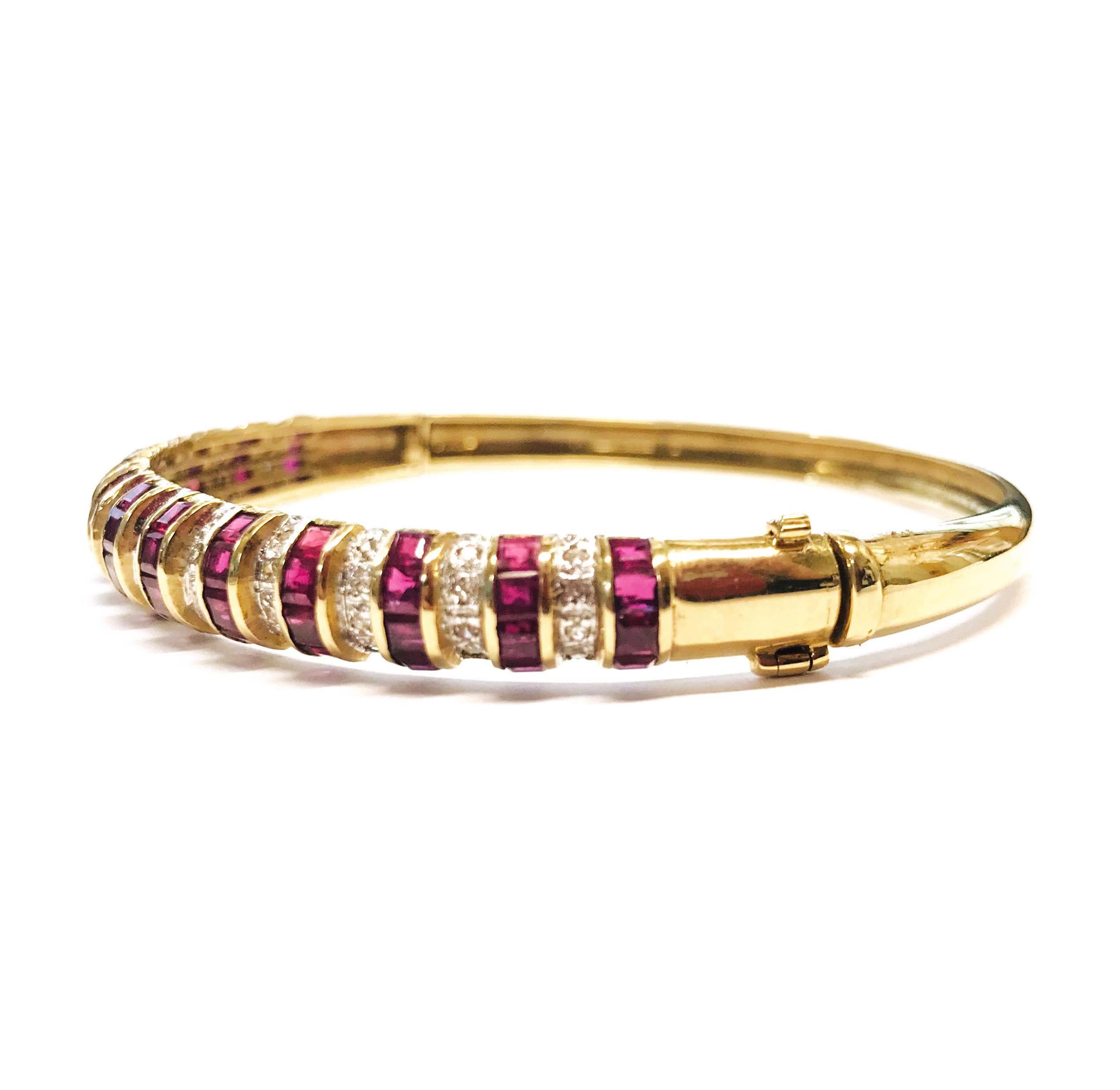 14 Karat Ruby Diamond Gold Bangle Bracelet. Alternating rows of princess-cut Rubies and round bead-set diamonds create this fabulously sparkly bracelet. 52 diamonds are I-1 in clarity (G.I.A.) and H-I in color (G.I.A.) and are a total carat weight