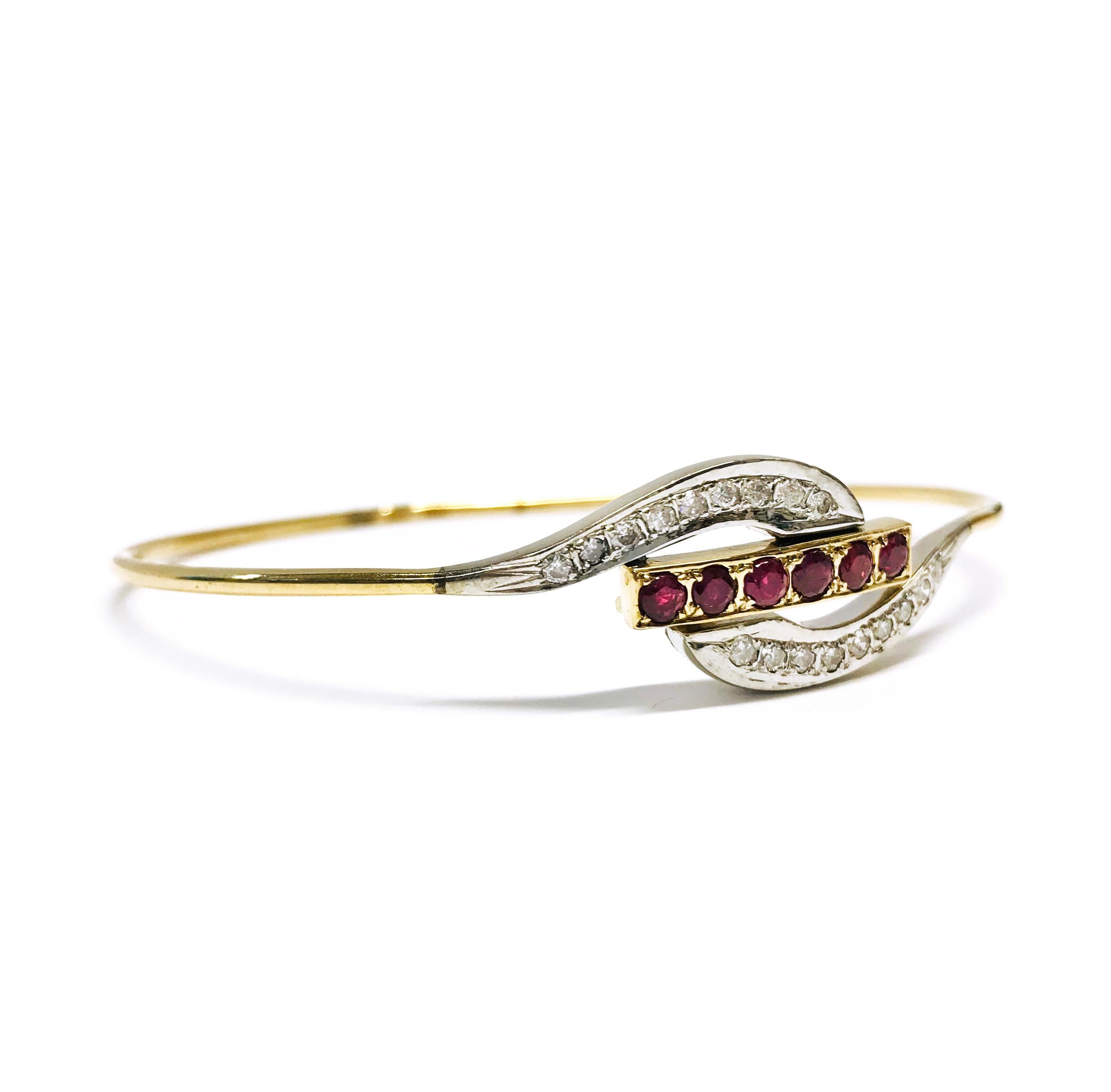 14 Karat Ruby Diamond Wire Bangle Bracelet. A center gold bar of six pave-set Rubies and two curves of eight melee pave-set diamonds each for a total of sixteen round brilliant-cut diamonds set in rhodium. Diamonds are I1 in clarity (G.I.A.). SIx