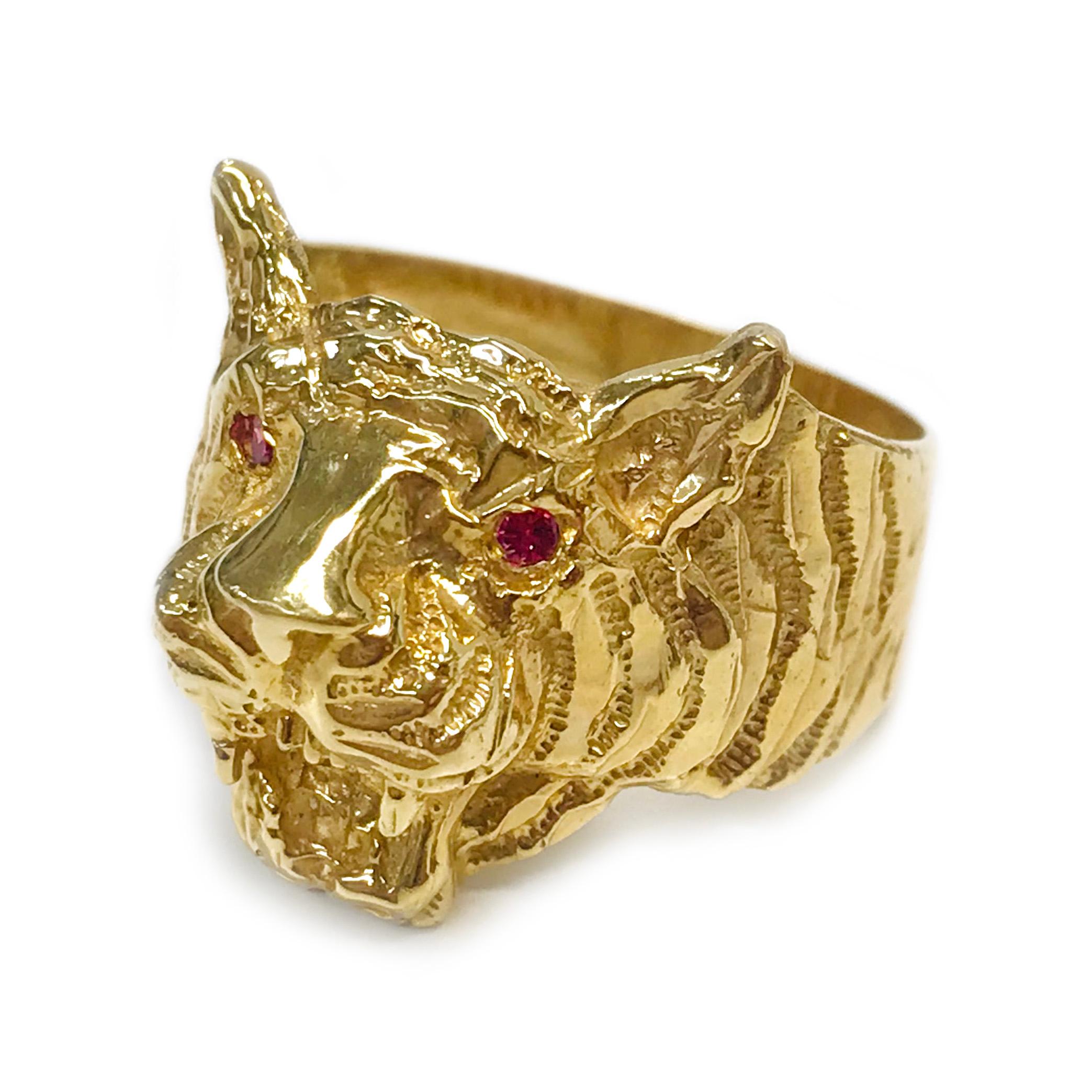 14 Karat Ruby Tiger Ring. This fantastic ring features a carved tiger face with round rubies flush-set as the eyes. The tiger stripes diminish as the face ends and the band begins and then tapers. Stamped on the inside band of the ring is 14K. The