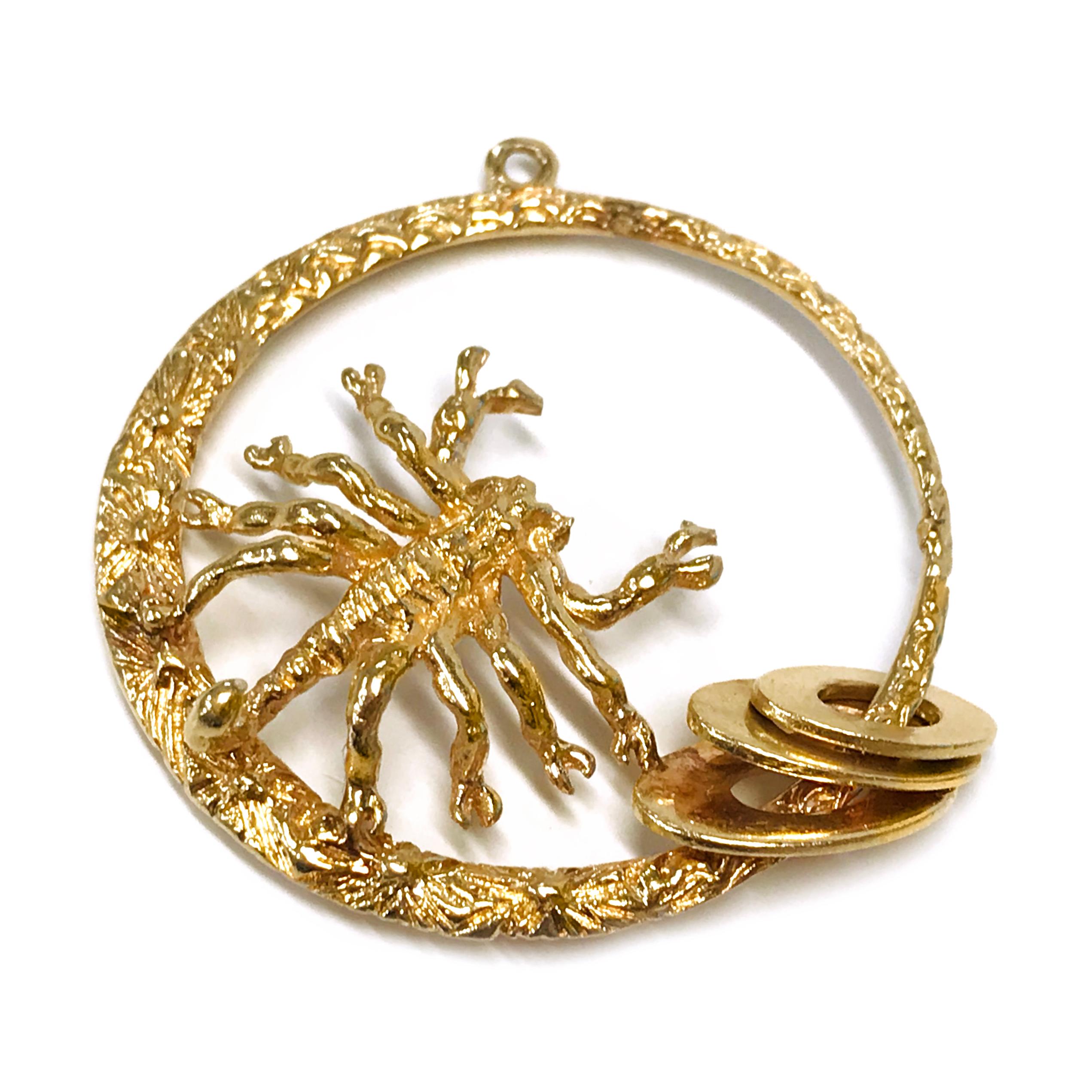 14 Karat Scorpion Pendant. The pendant measures 37.35mm in diameter. The pendant features a thin to wide circle with a scorpion that is facing the center of the pendant with three smooth oval discs near the bottom. The pendant circle is highly
