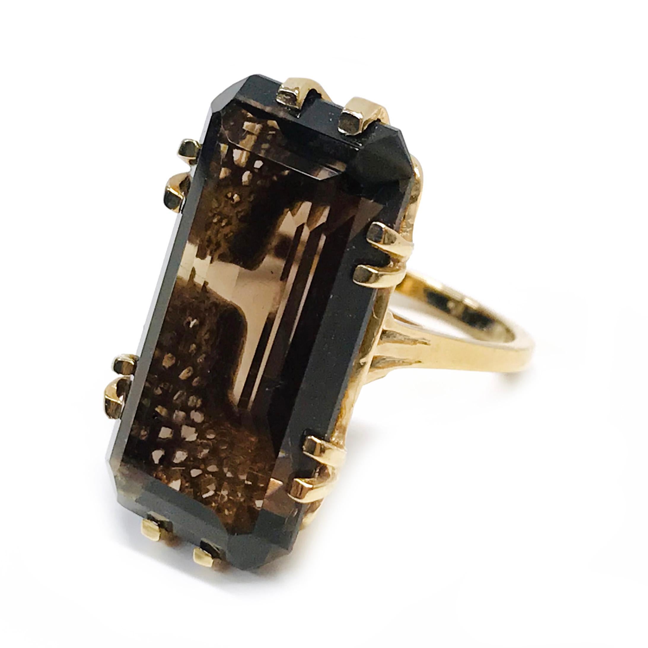 14 Karat Smoky Quartz Ring. The ring features a 24 x 12mm step-cut Smoky Quartz. The ring has a mesh looking basket and six dual prongs. Stamped on the inside of the band is TB 14K. The ring size is 6 and has a gold weight of 7.7 grams. 