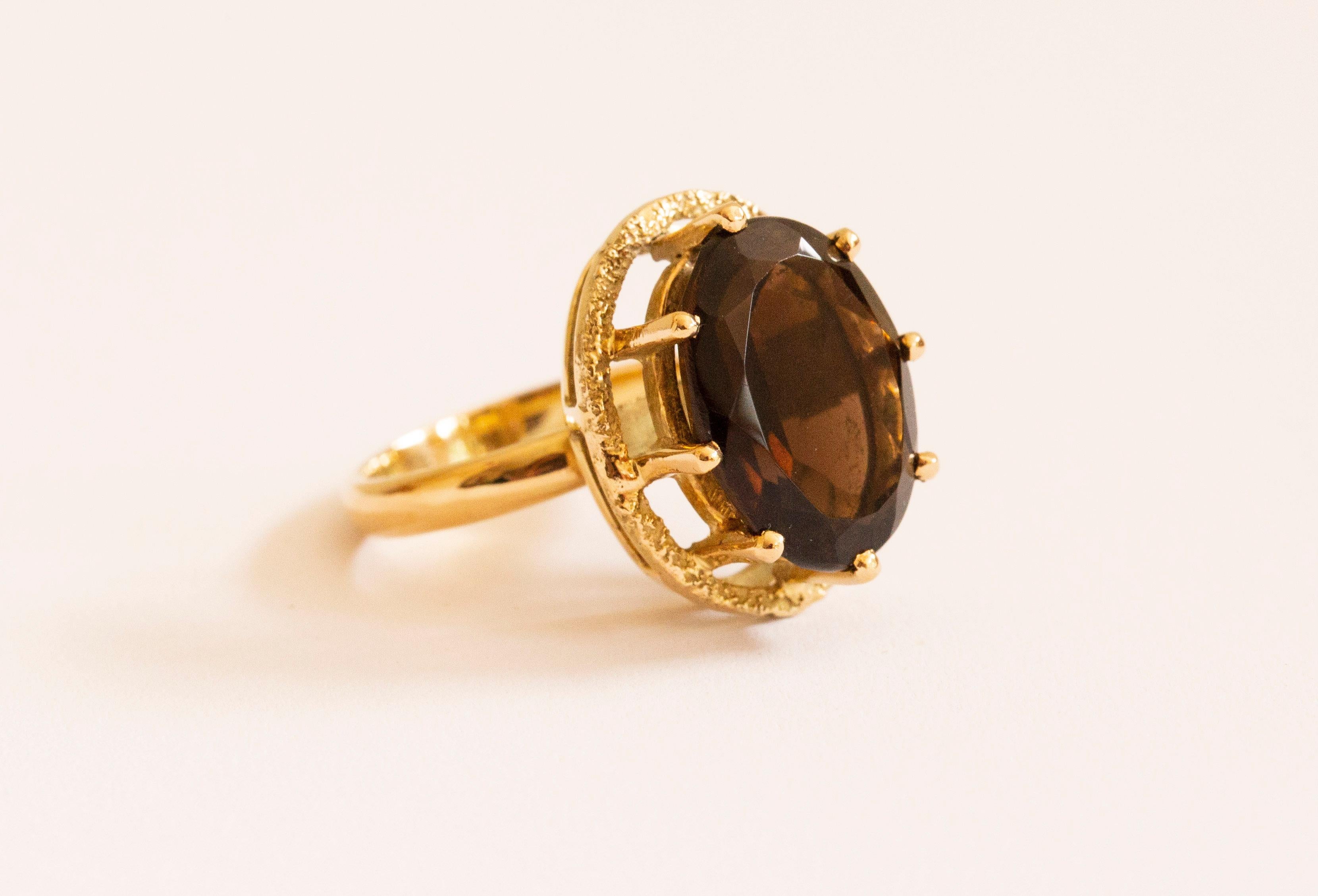 A vintage ring made of 14 karat solid yellow gold with a faceted smoky quartz. The ring is stamped with 585 that stands for 14 karat gold content and it was tested by a professional jeweler for the gold content and the authenticity. The ring is in