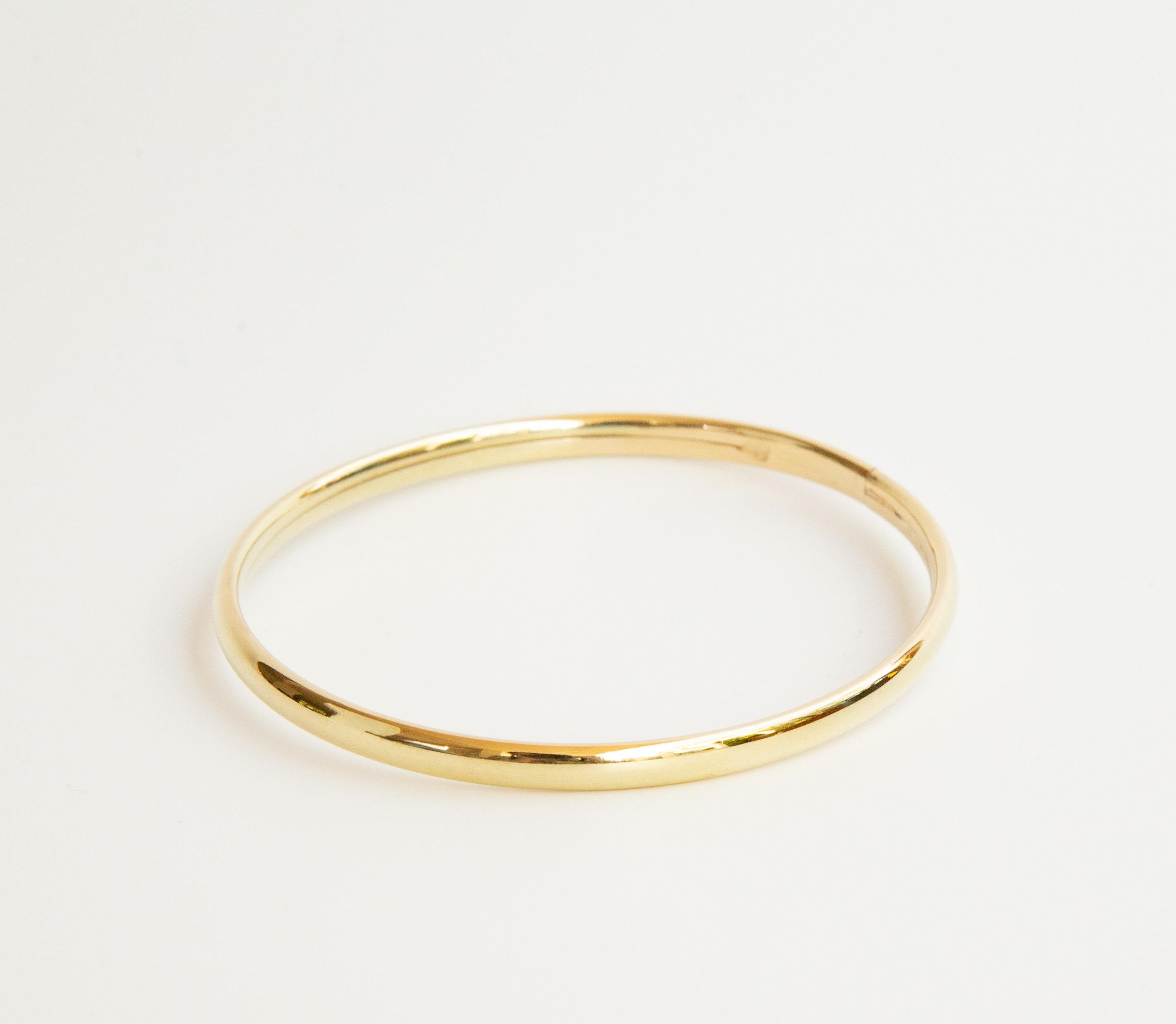Un bangle vintage, bracelet rigide en or jaune massif 14 carats. Le bracelet est doté d'un fermoir en forme de boîte. Le bracelet est en très bon état vintage avec de très légères rayures superficielles uniquement visibles lorsque l'objet est