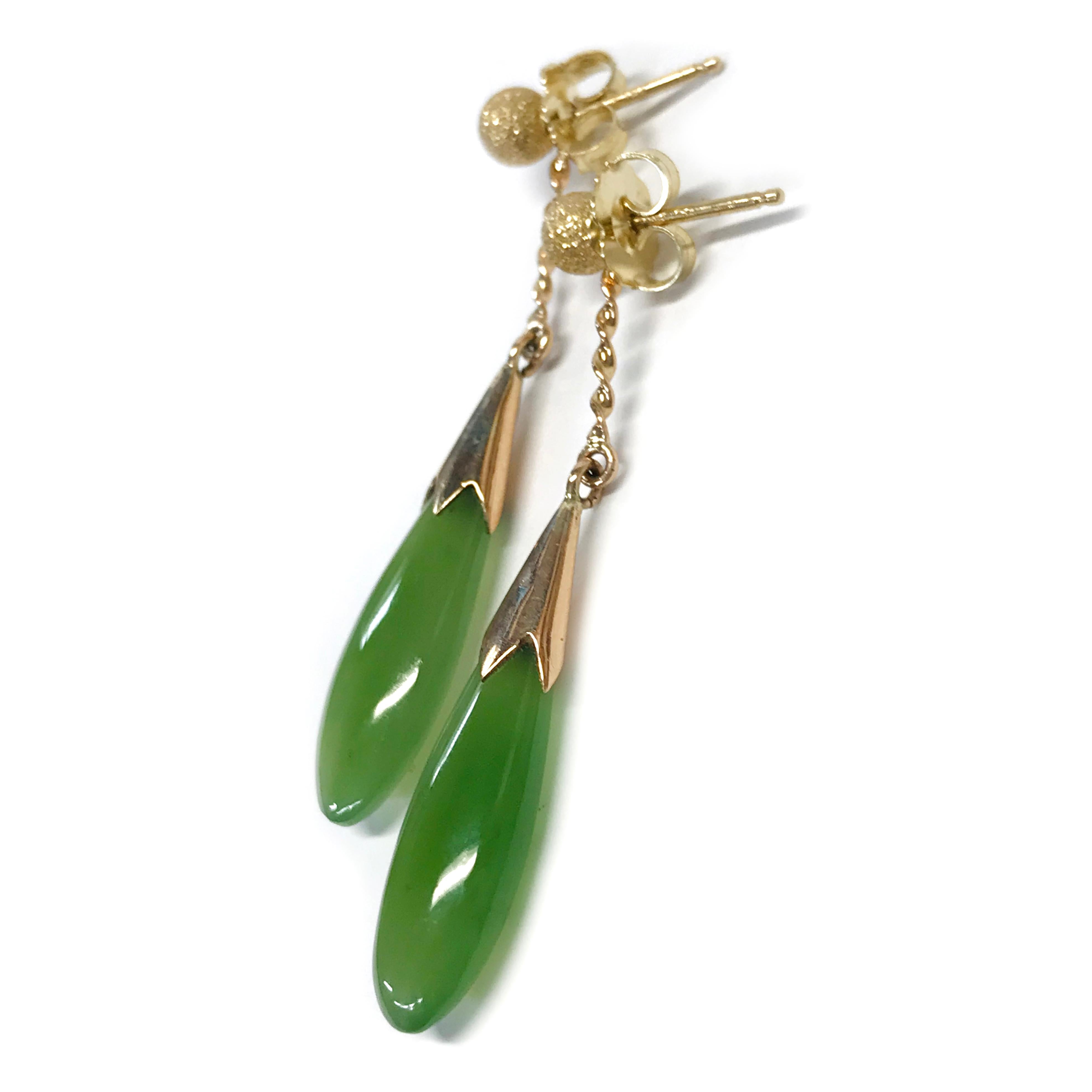 14 Karat Stardust Studs with Teardrop Jade Jackets. These earrings contain a 4mm round gold stardust/stone finish bead stud with a teardrop Jade jacket. The jackets contain a thin twisted gold bar followed by a gold cone-shape with a teardrop Jade.
