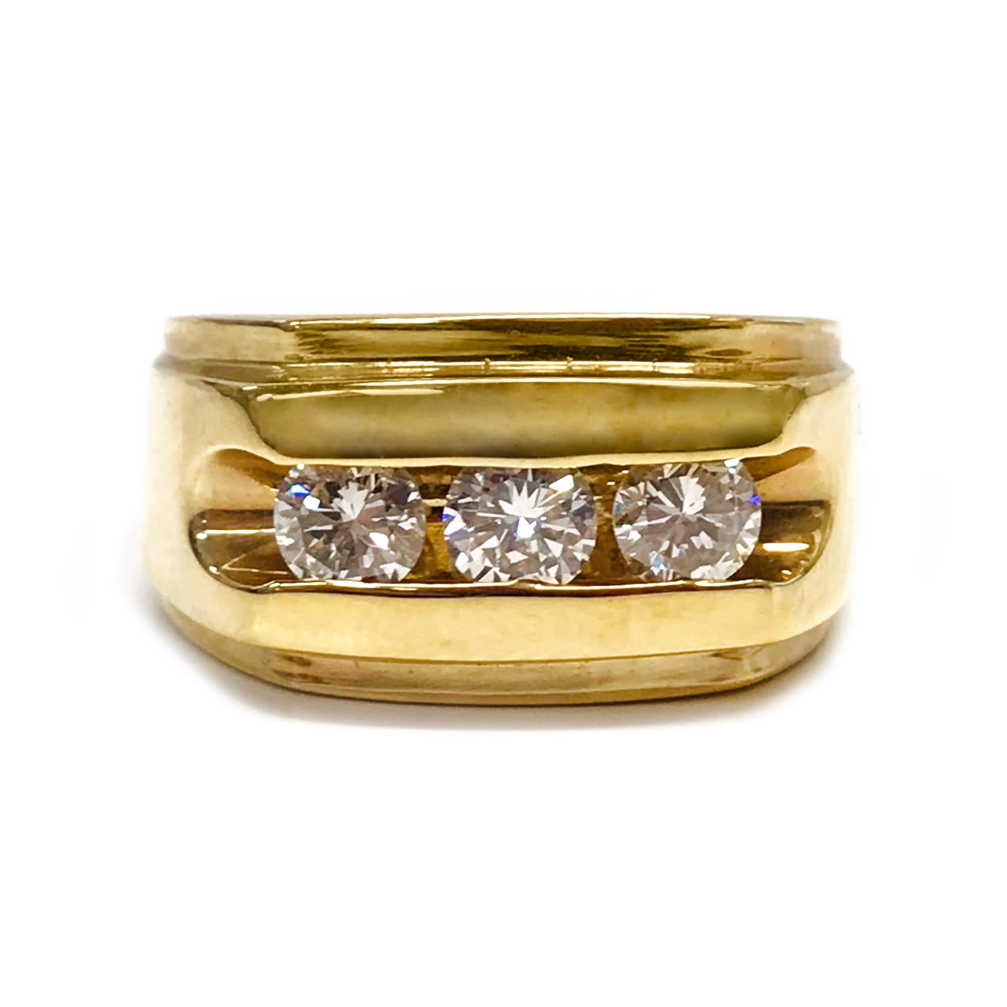 14 Karat Three Diamond Wide ring. The ring features a wide band that tapers and three round diamonds channel-set in the center. The diamonds have a total carat weight of 0.75ctw. Stamped on the inside of the band is 14K IGM. The ring size is 9 1/4