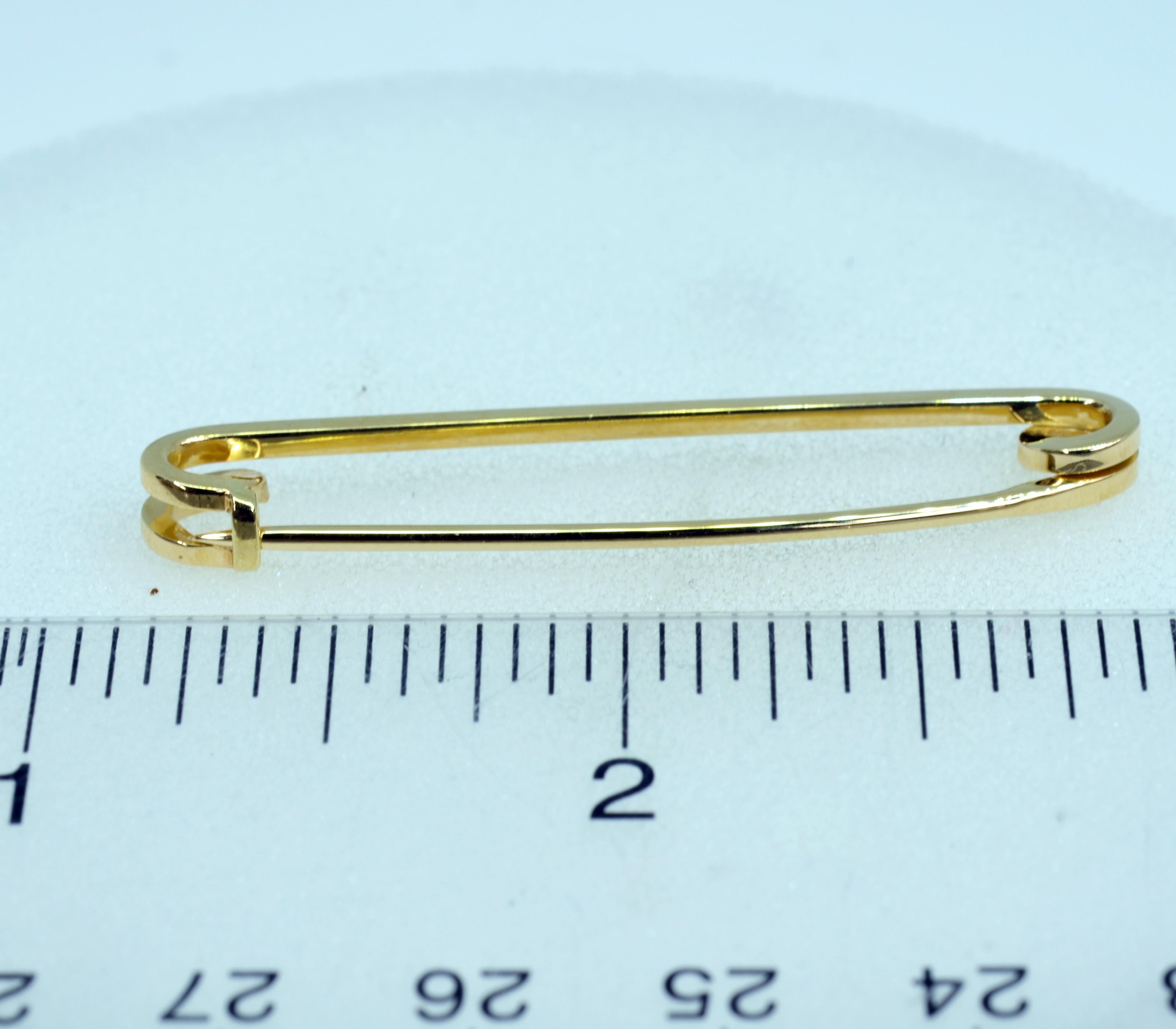 Classic Tiffany safety pin crafted in 14 Karat gold, perfect for a scarf or a lapel.. This pin is 1.8 inches (45.6mm) in length.