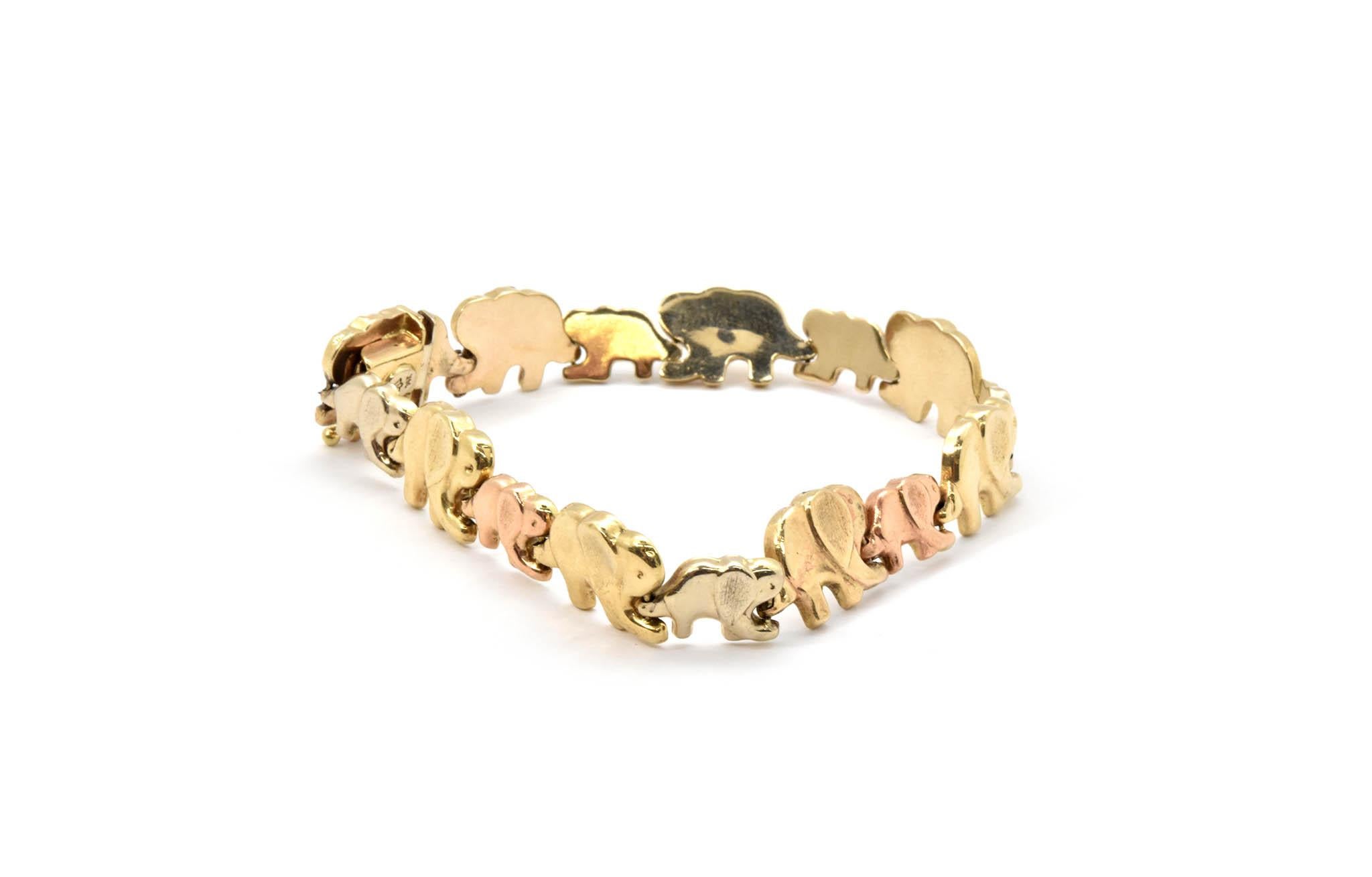 Elephants on parade!  This is a 14k tri-color gold bracelet made with elephant links lined up trunk to tail. The elephant bracelet measures 7” inches long. The large elephants are in yellow gold and measure 10.85mm wide. The small elephants measure