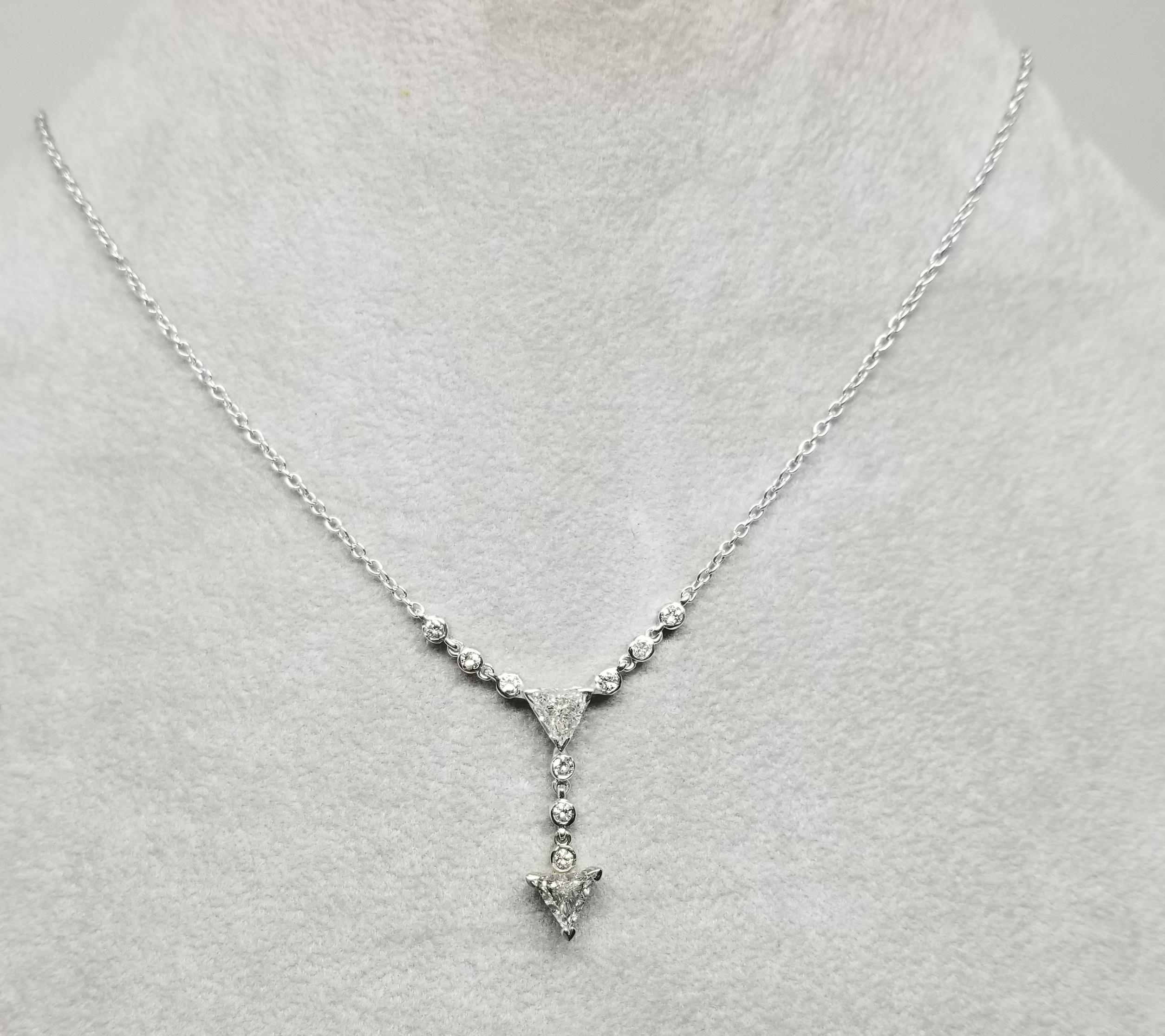 14 karat  Triangle diamond dangle pendant, containing 2 triangle cut diamonds weighing .90pts. and 9 round full cut diamonds weighing .30pts. on a 16 inch small link chain.