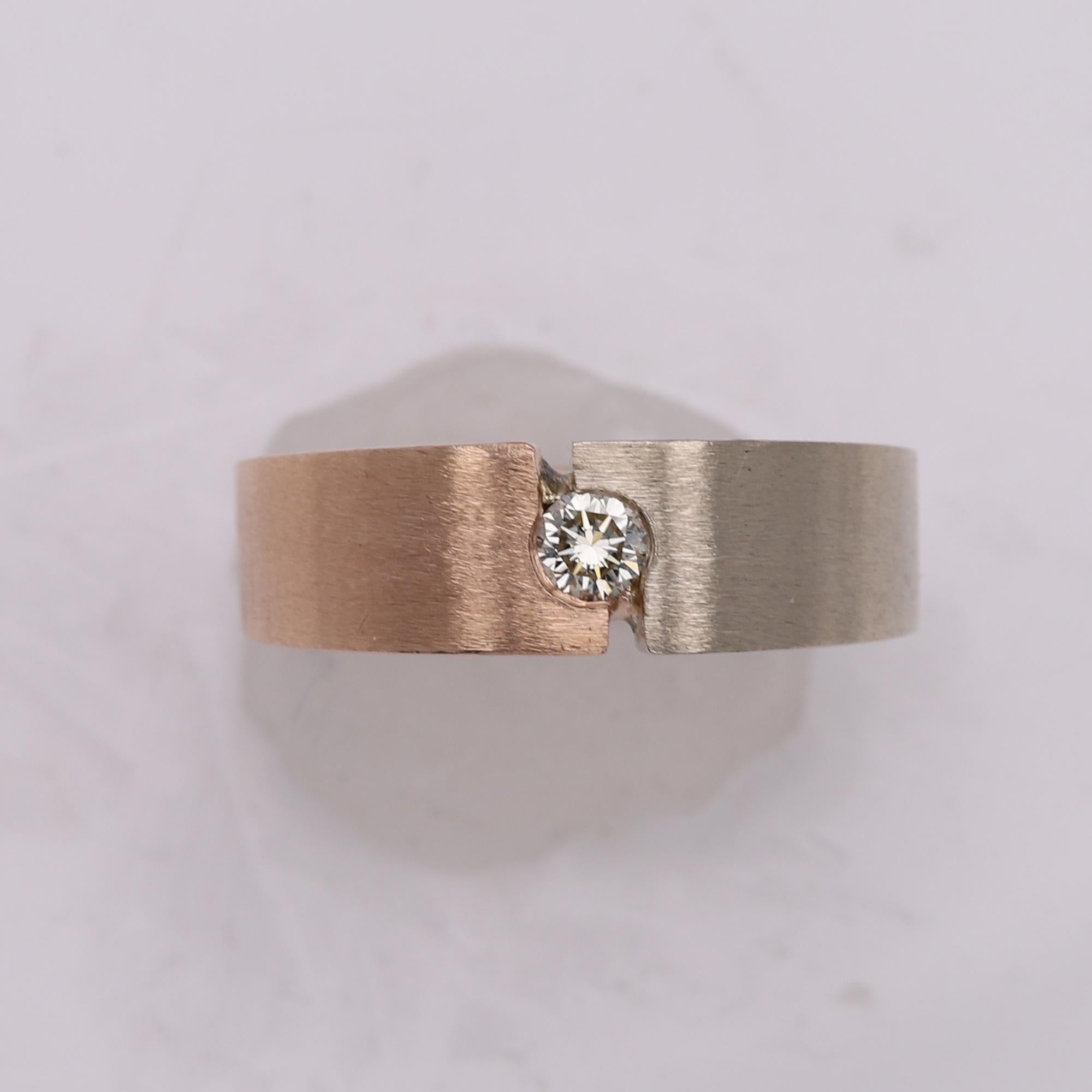Pre- owned in great condition -as new
14k Two tone - Rose and White Gold
brilliant center natural diamond H-SI-VS very shiny diamond
diamond size 0.40 mm / 0.25 carat
Total gold weight 13 grams
brushed finish - very cool.
Band width on top approx.