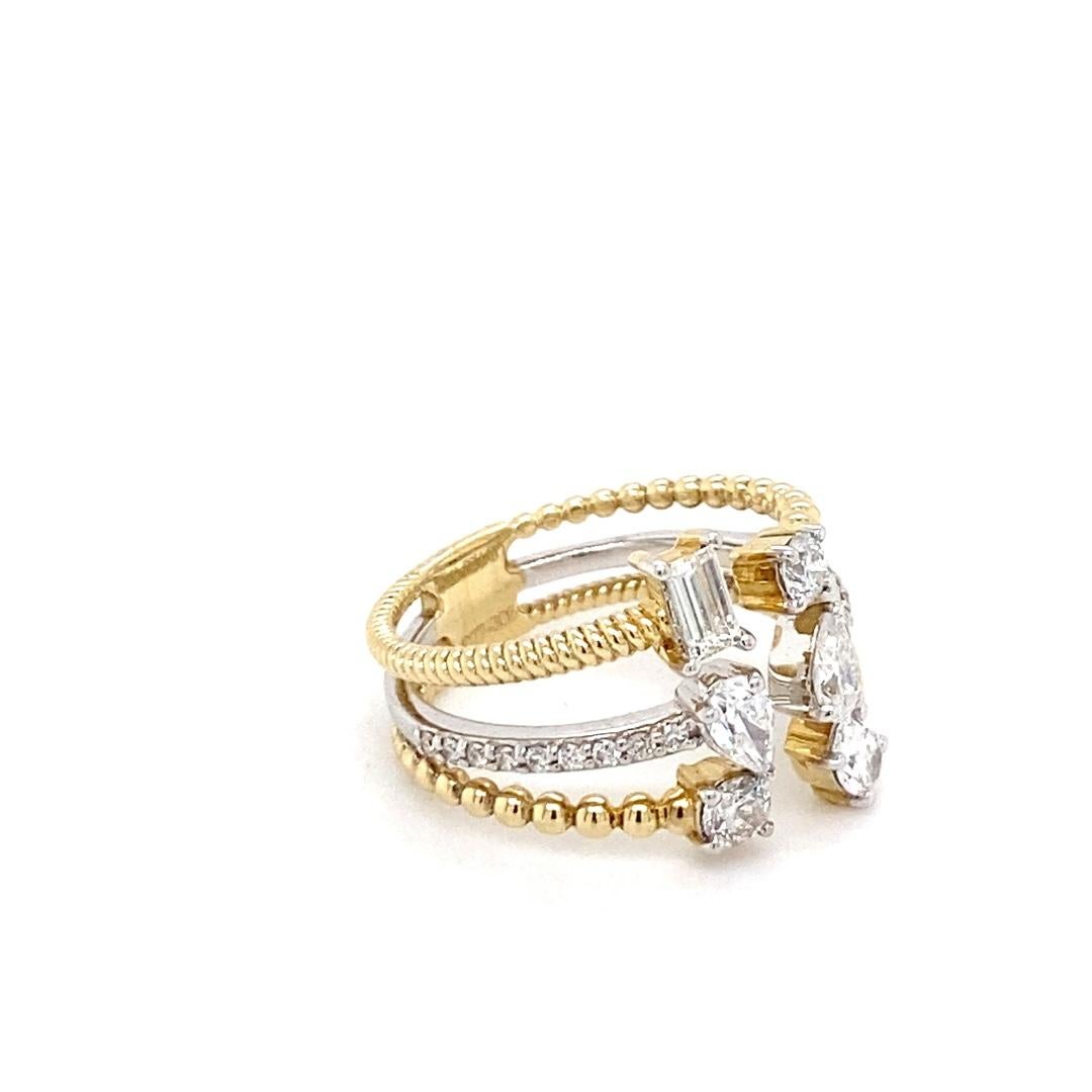 This stunning ring is made in 14 karat gold and has a total diamond weight of 0.86cttw. It has a stackable look with an open front. The ring features several different shaped diamonds and is a very unique piece. Don't miss out on this one of a kind