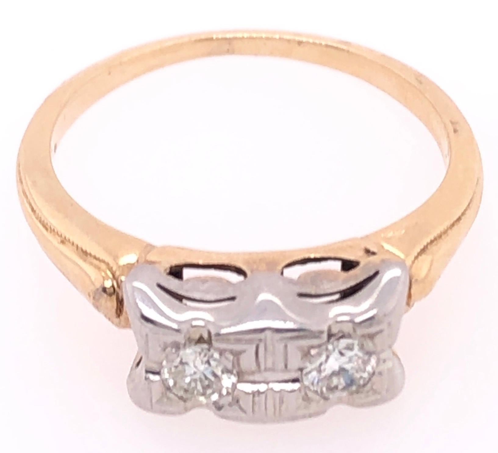 14 Karat Two Tone Fashion Ring with Diamonds 0.25 Total Diamond Weight.
Size 6
2.72 grams total weight.
