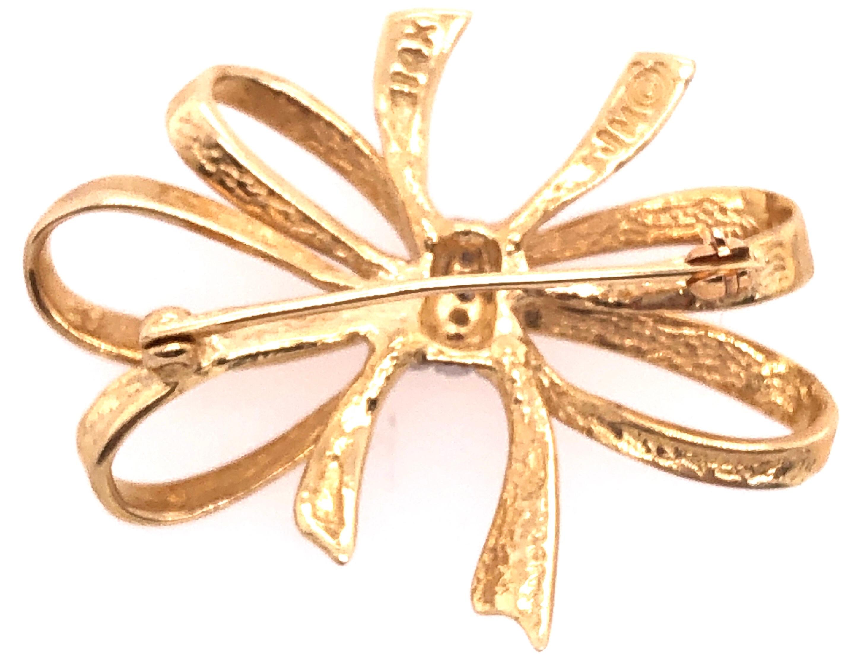 14 Karat Two Tone Yellow and White Gold Bow Brooch with Diamond Accents
0.04 total diamond weight.
4.89 grams total weight.