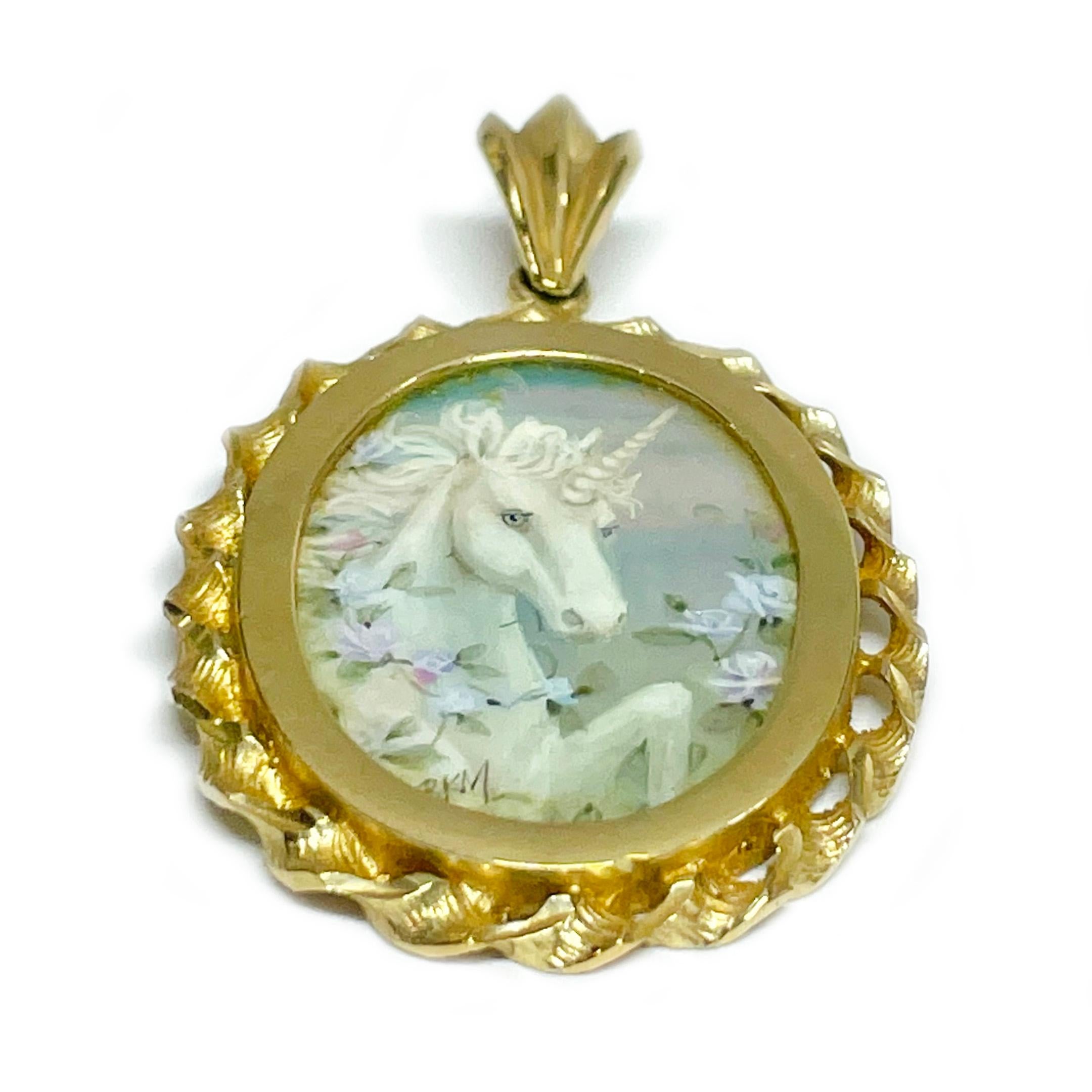 14 Karat Yellow Gold Unicorn Hand Painted on a Mother of Pearl Pendant. The miniature painting is set in a 14 karat gold twisted rope oval frame with diamond-cut details. The painting is signed by the master artist, BKM Brian M. and includes a