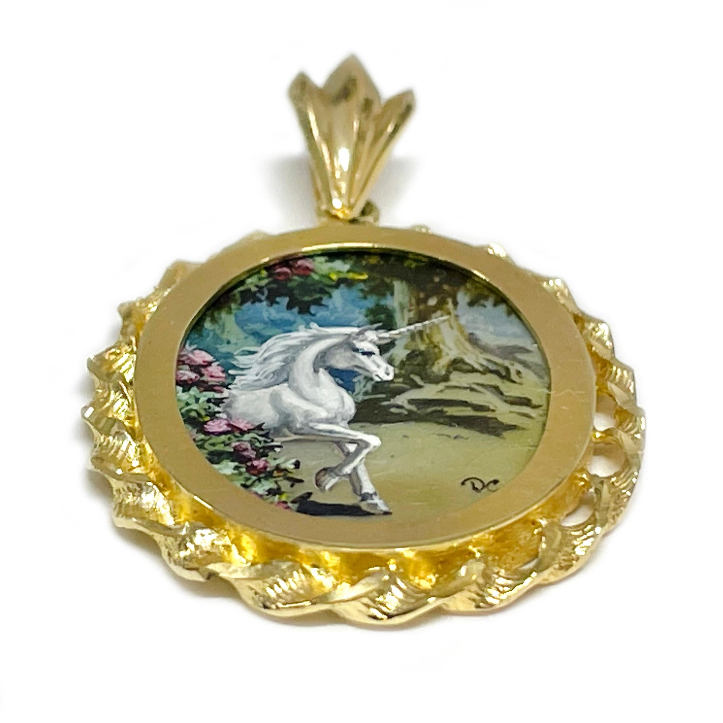 14 Karat Yellow Gold Forest Unicorn Hand Painted on a Mother of Pearl Pendant. The miniature painting is set in a 14 karat gold twisted rope oval frame with diamond-cut details. The painting is signed by the master artist, DC Darryl C. and includes