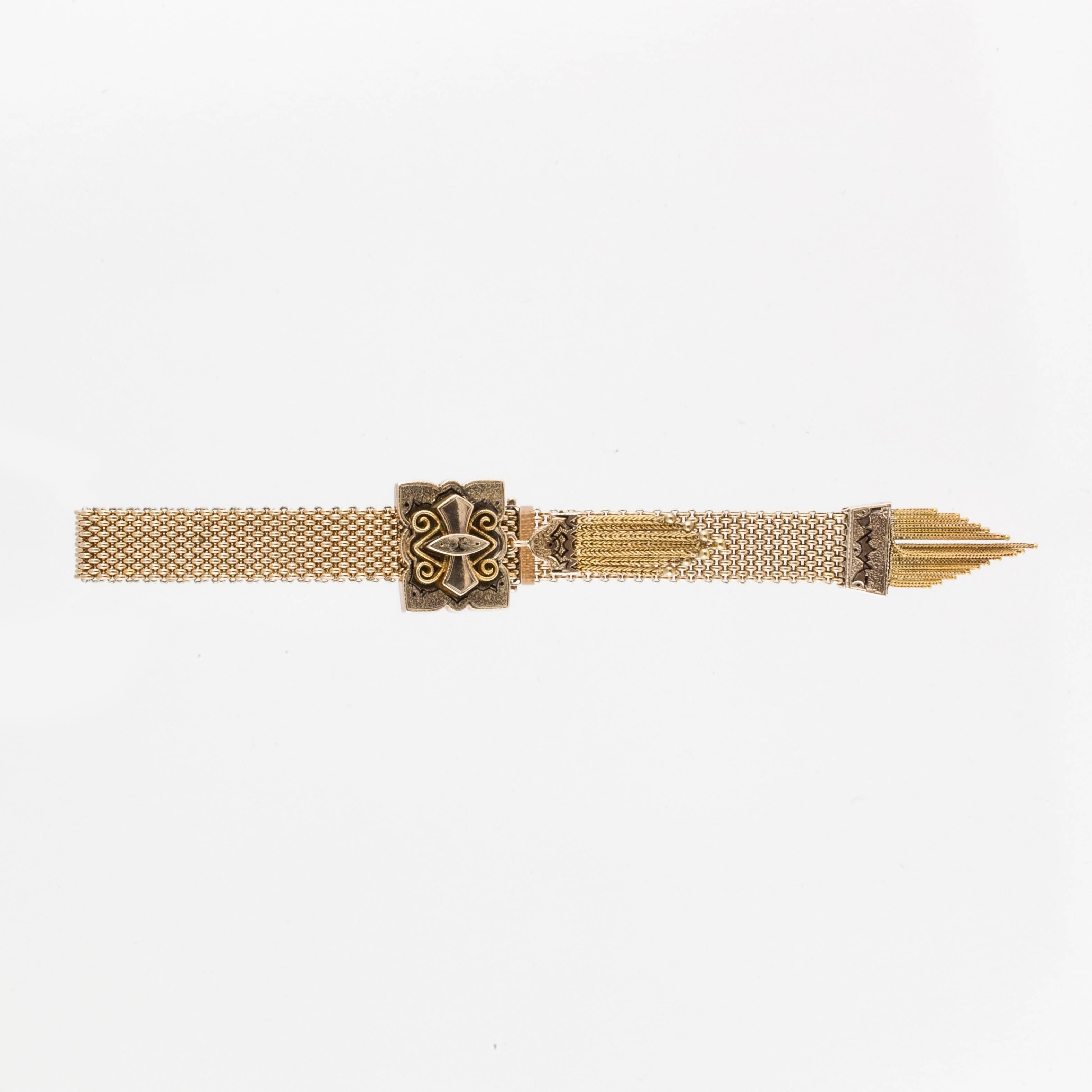 Victorian tassel bracelet in 14K yellow gold.  The tassels are complete with all of the balls intact.  The plaque measures 7/8 inches by 3/4 inches and the bracelet is 1/2 an inch wide.  Enamel is still in good condition.