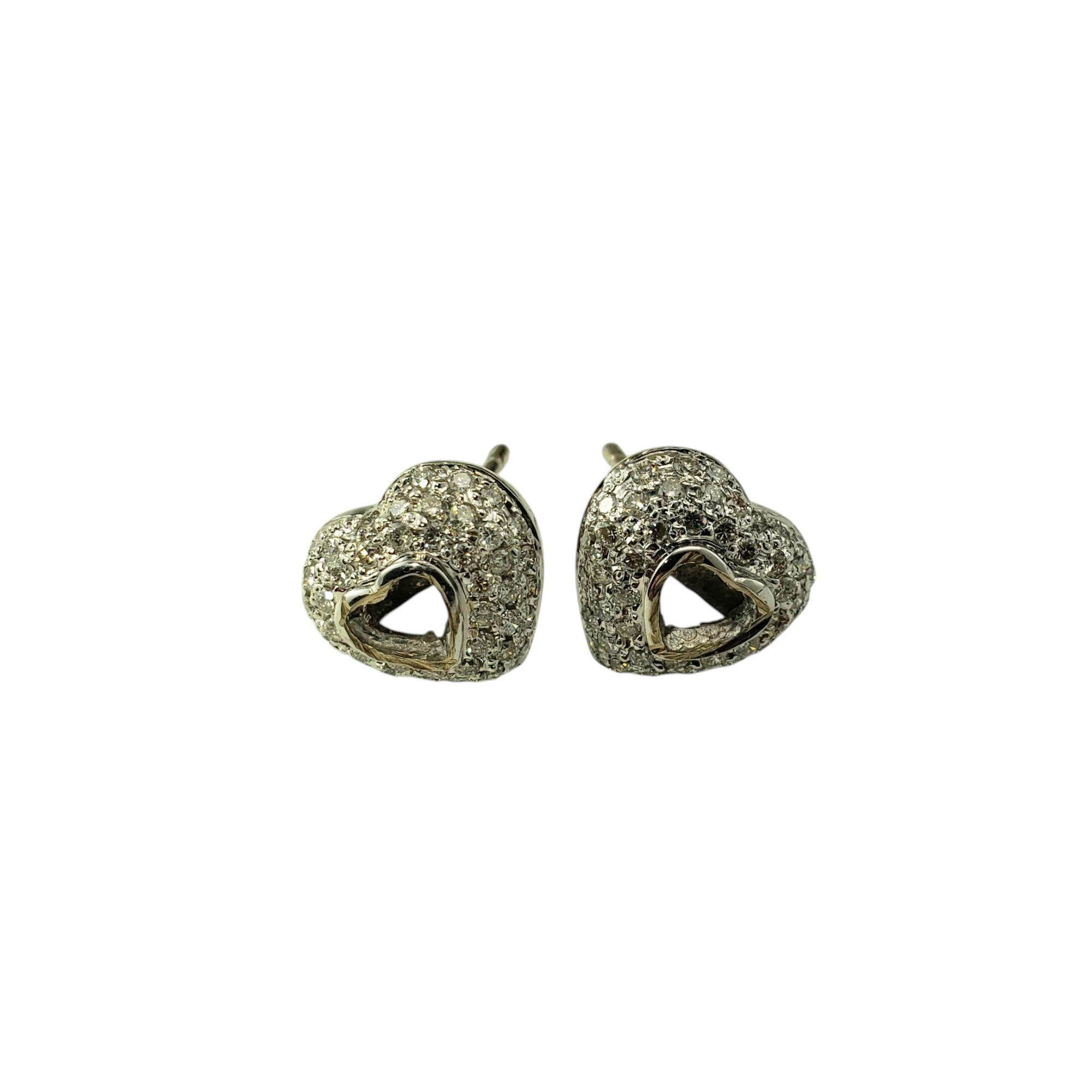 14 Karat White and Yellow Gold and Diamond Heart Stud Earrings-

These sparkling 14K white and yellow gold stud earrings each feature 50 round brilliant cut diamonds set in a lovely heart design. Push back closures.

Approximate total diamond
