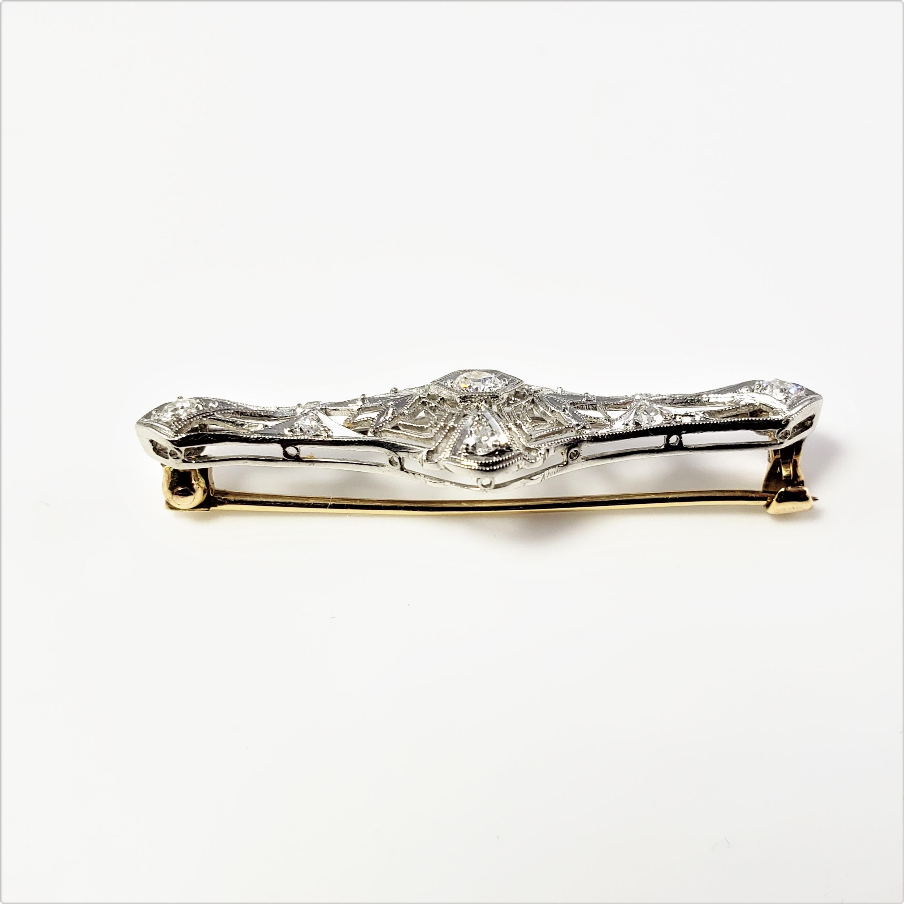 14 Karat White and Yellow Gold Filigree and Diamond Bar Pin/Brooch-

This exquisite brooch features nine round European cut diamonds set in beautifully detailed white gold filigree.  Pin is yellow gold.

Approximate total diamond weight:  .30 ct. 