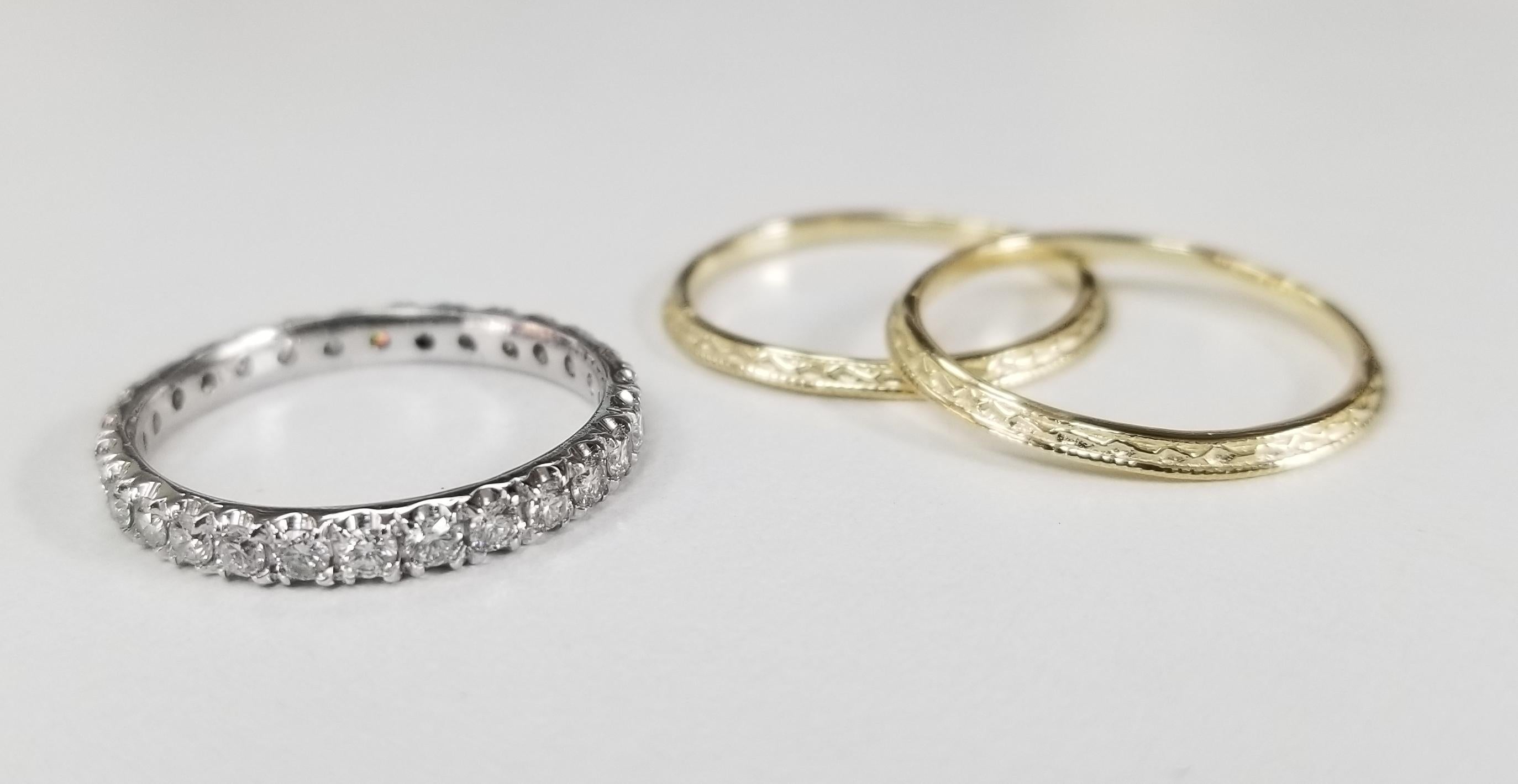 14k white gold diamond eternity ring with 28 round full cut diamonds of very fine quality weighing .70pts. with 2 14k yellow gold hand engraved beveled rings.  3 separate rings to mix and match. size 6