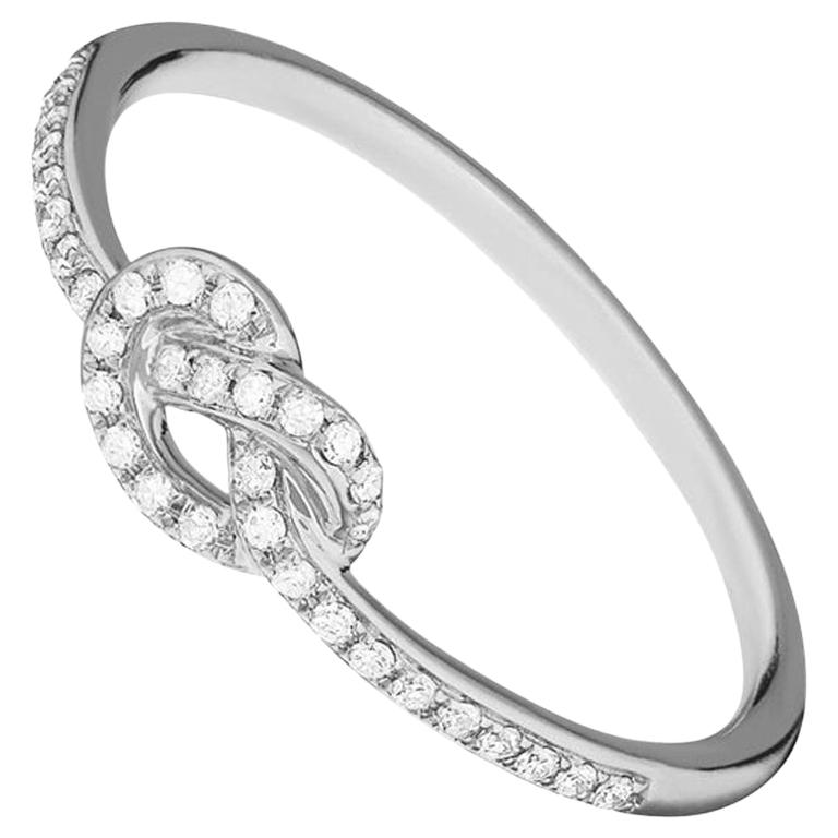 For Sale:  14 Karat White Gold 0.107 Carat Knot Round Diamond Ring