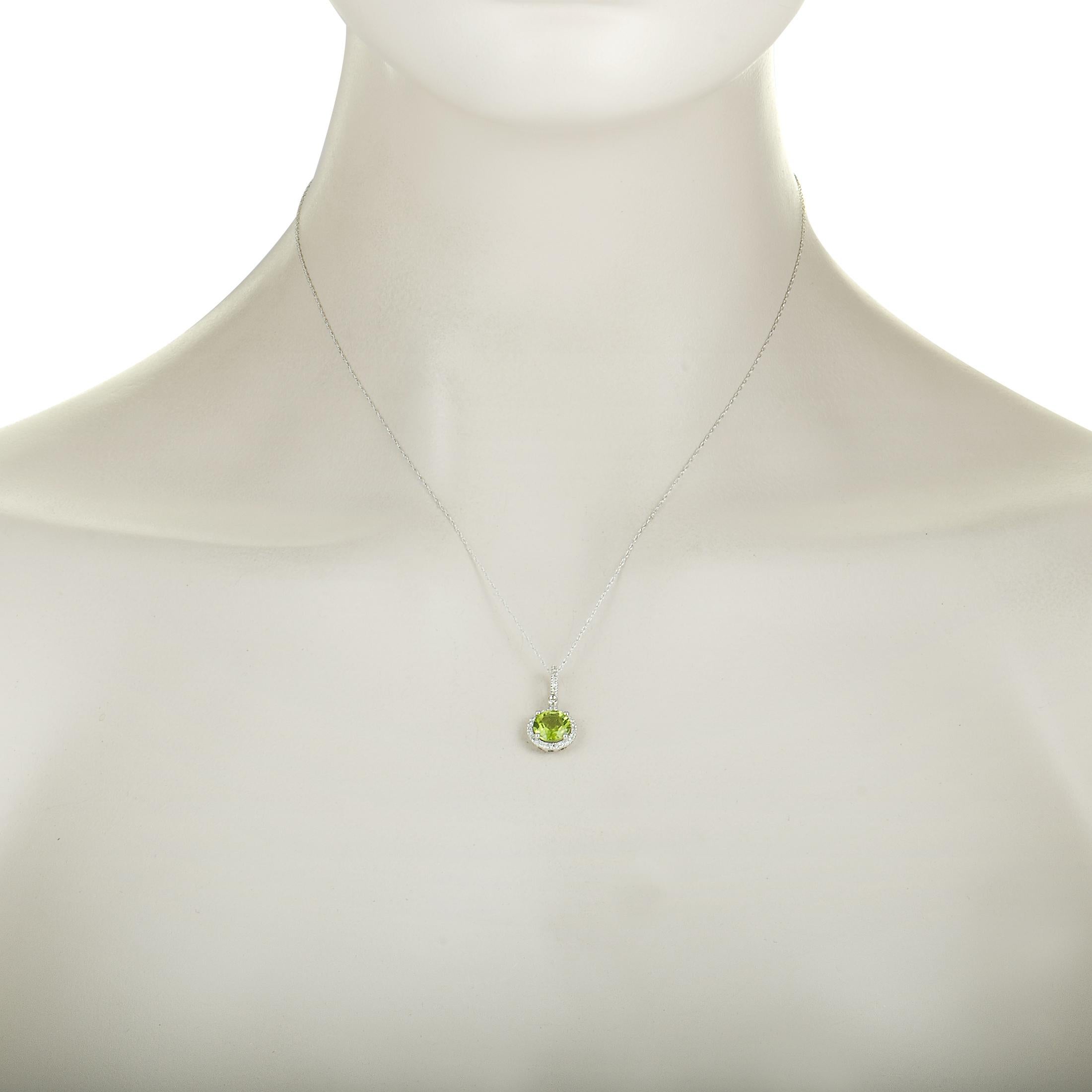 This necklace is crafted from 14K white gold, weighs 2.2 grams, and is set with a peridot and a total of 0.11 carats of diamonds. The chain features spring ring closure and is 17.00” long, while the pendant measures 0.80” in length and 0.45” in