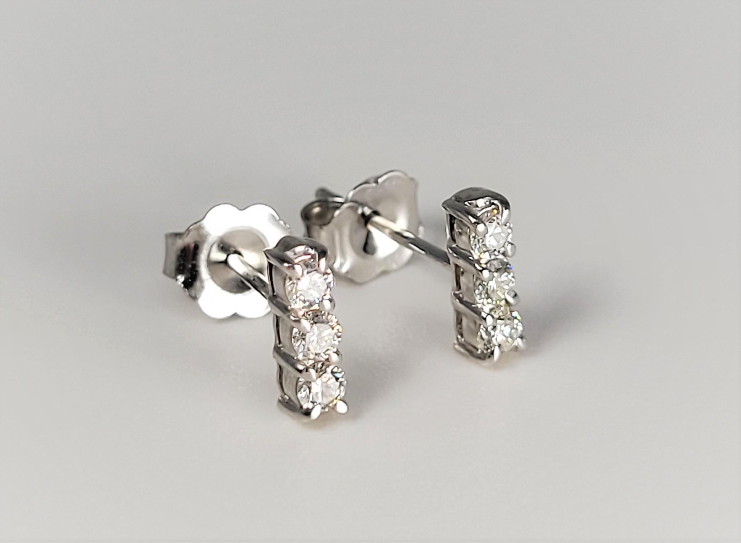 In a 3 diamond row, these sweet earrings are in 14 karat white gold and support a total of 0.24 carats. 