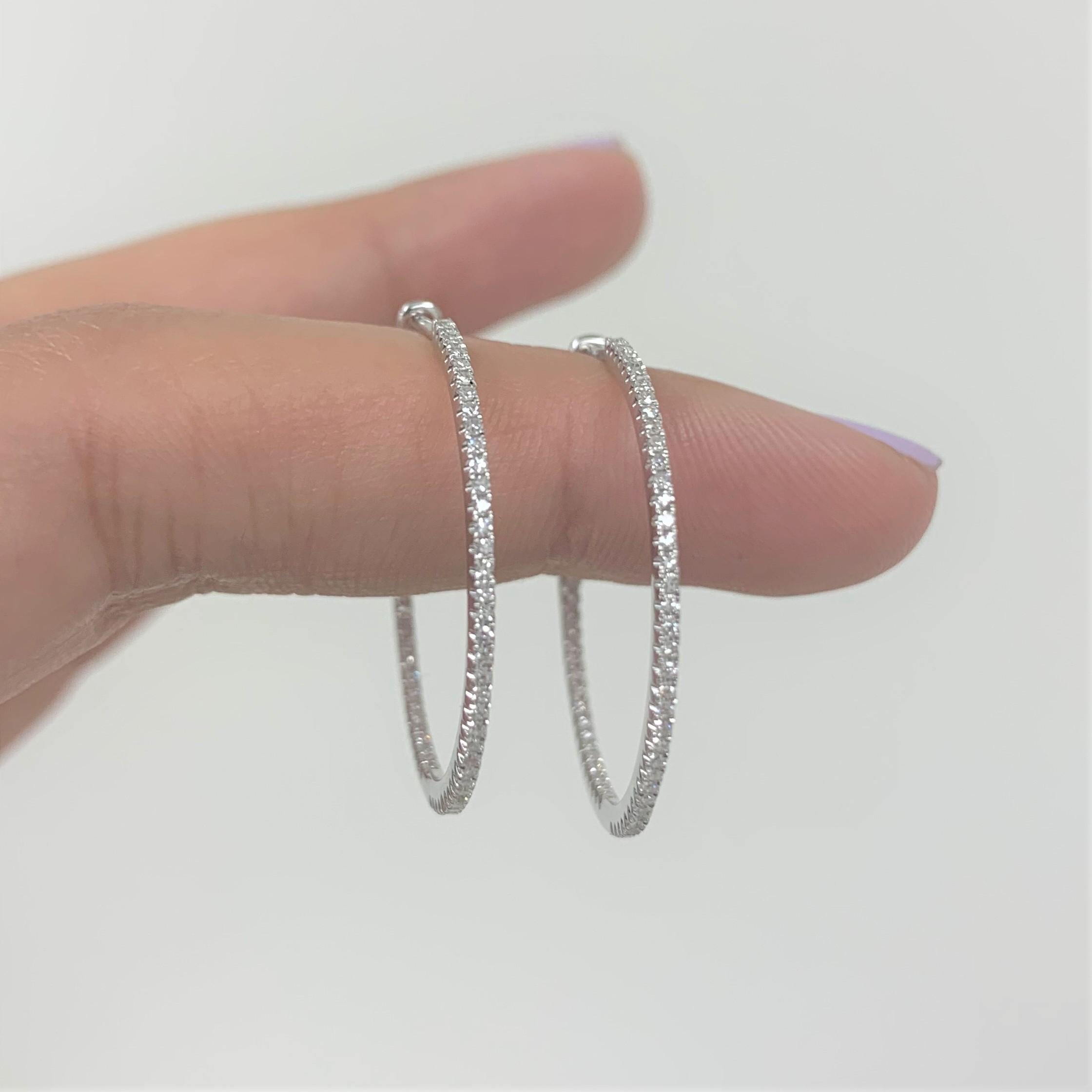 Light up your favorite looks with the brilliance of diamonds! Shimmering and bright, these gorgeous narrow round hoops glisten with approximately 0.30ct diamonds along the outer edge. Diamond color and clarity is GH SI1-SI2. Lever backs provide a