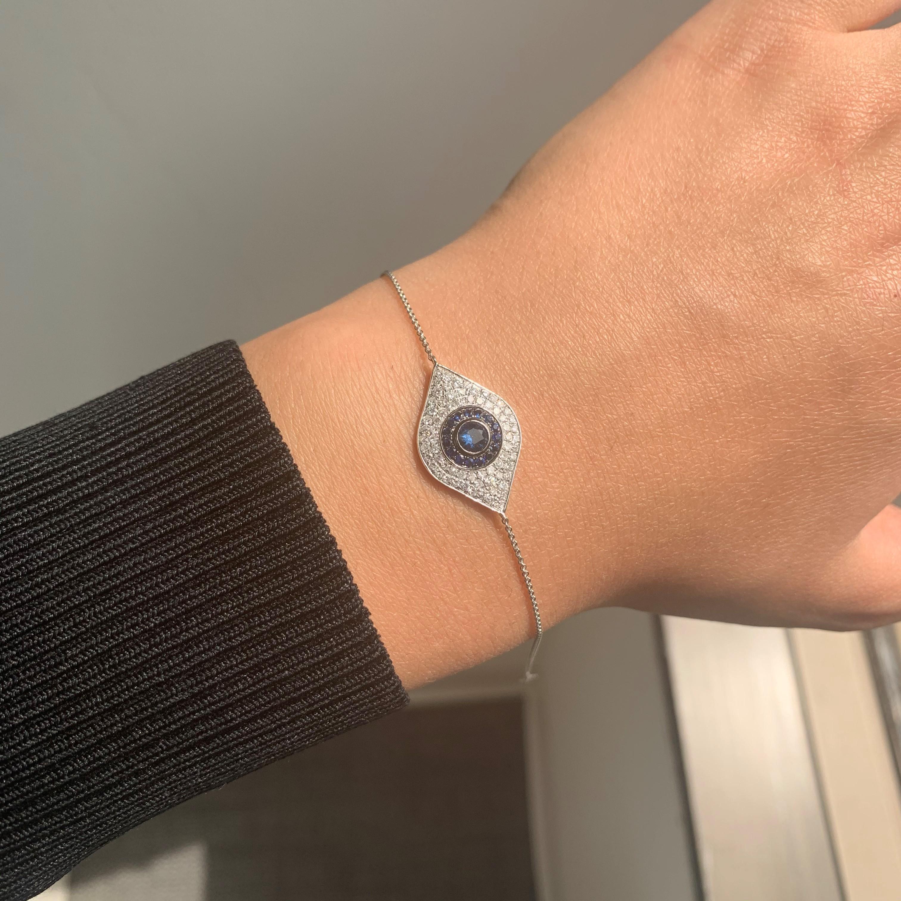 Show off your unique style with this striking Evil Eye Bracelet. This bracelet is crafted of 14k white gold and features approximately 0.37 ct of genuine white diamonds and 0.45 ct of Blue Sapphire. Diamond color and Clarity GH SI1-SI2. Adjustable