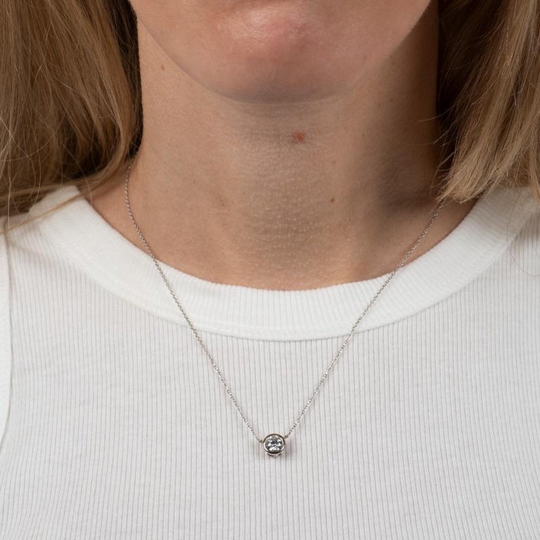 This necklace features a 0.78 carat diamond, F I1, bezel-set in 14 karat white gold. The chain is 14 karat white gold adjustable chain from 16-18