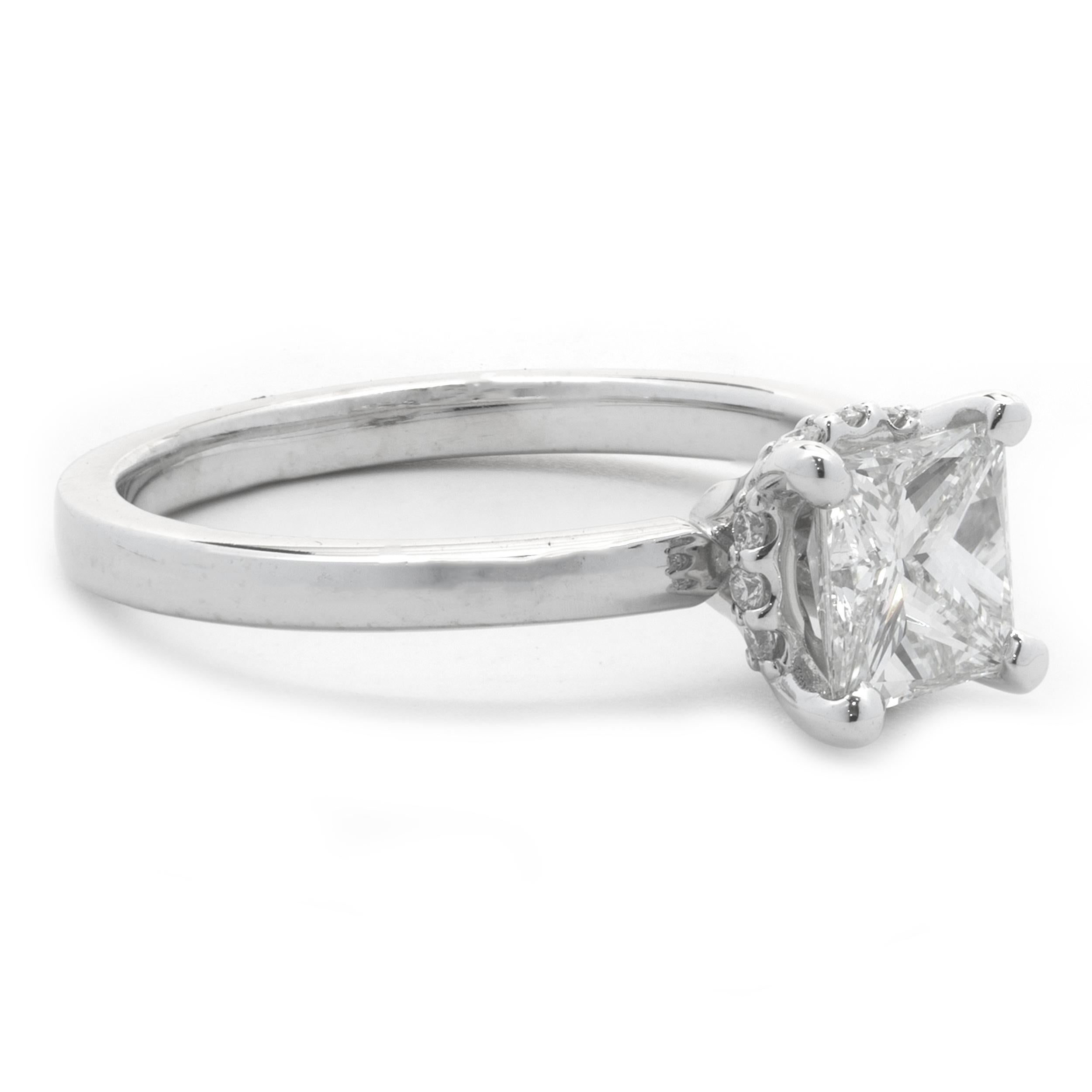 Designer: custom
Material: 14K white gold
Diamond: 1 princess cut = 0.78ct 
Color: I
Clarity: VS2
Diamond: 12 round brilliant cut = .12cttw
Color: G
Clarity: VS2
Ring Size: 5 (please allow up to 2 additional business days for sizing